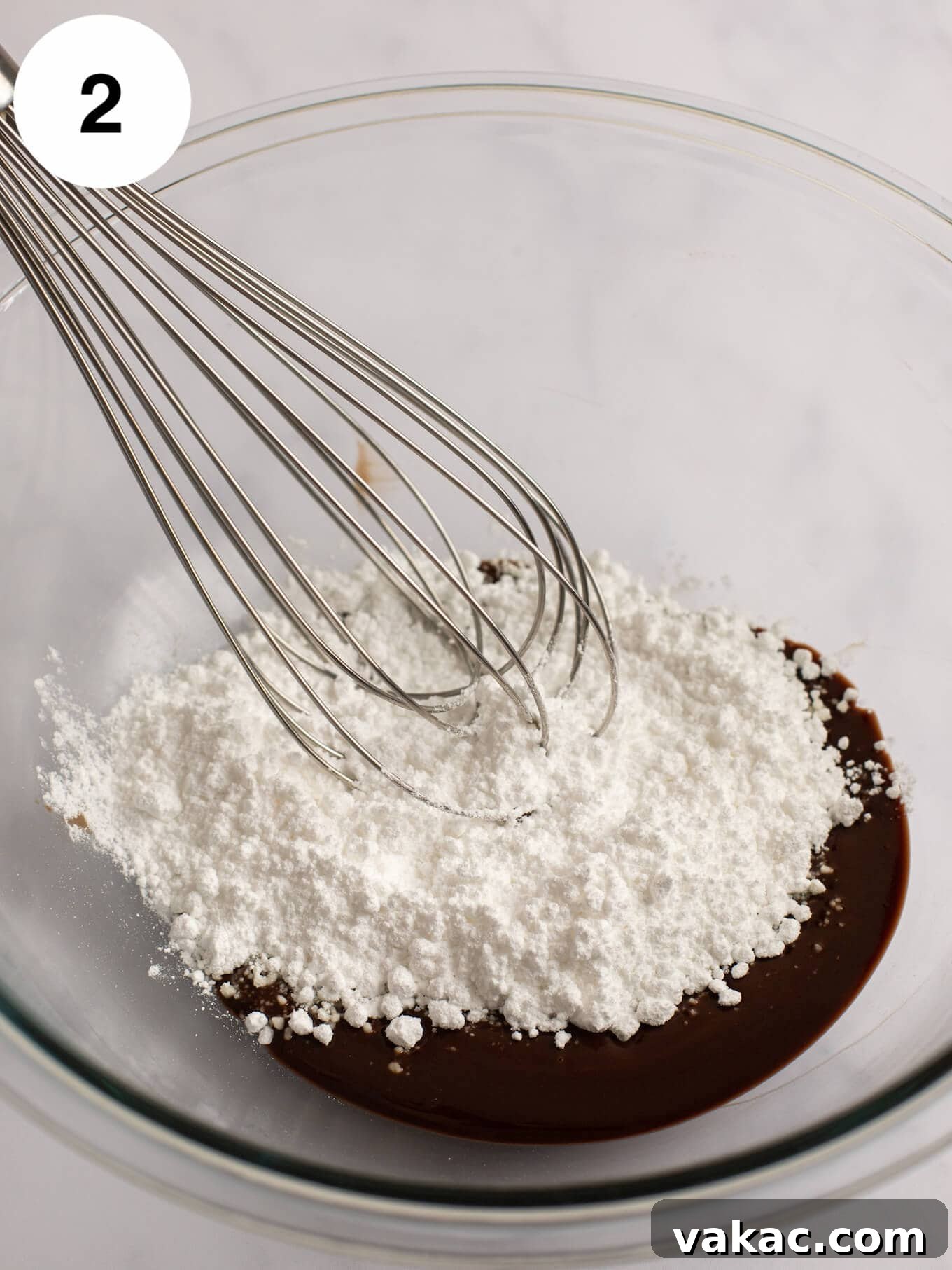 Decadent Molten Chocolate Lava Cake Perfection 5 Powdered sugar being added to the melted butter and chocolate.
