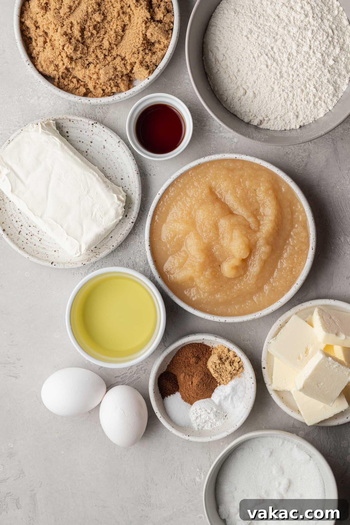 An inviting overhead view of all the essential ingredients laid out neatly on a kitchen counter, ready for baking a homemade spiced applesauce cake.