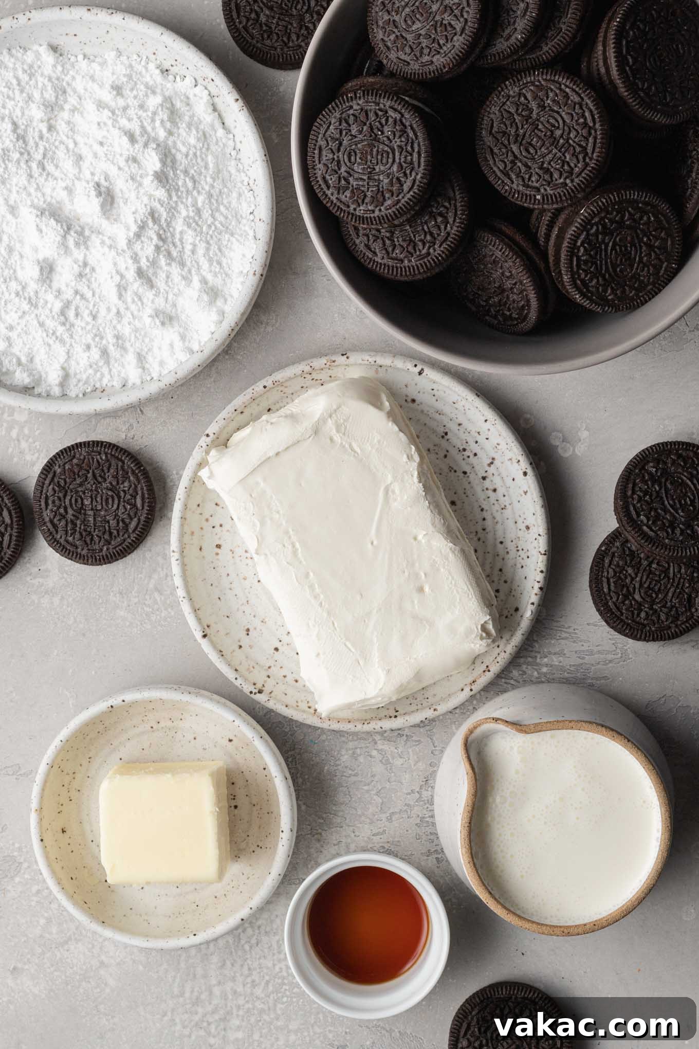 Irresistible Oreo Dream Pie 3 An overhead view of the various ingredients needed to make an Oreo pie, including Oreos, butter, cream cheese, powdered sugar, heavy cream, and vanilla extract.