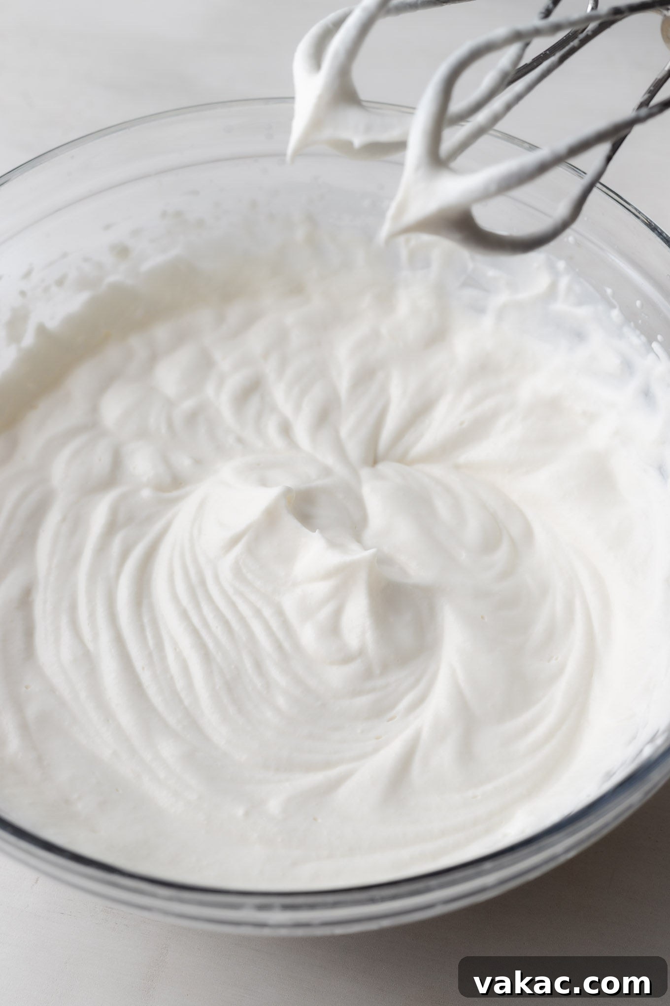 Irresistible Oreo Dream Pie 6 An overhead view of whipped cream beaten to stiff peaks, standing firm in a mixing bowl.