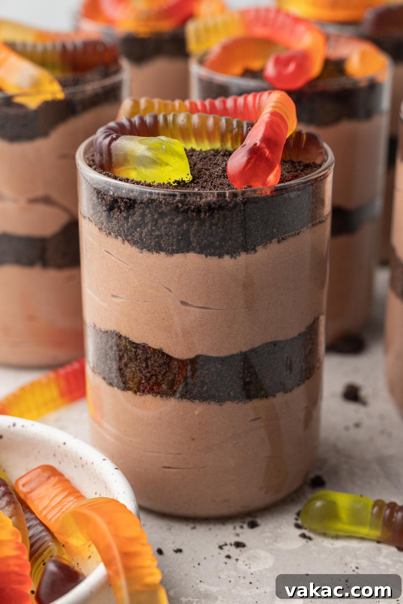 Sweet Soil Treats 2 Layered Oreo dirt cups with gummy worms on top, showcasing the dessert's classic presentation.