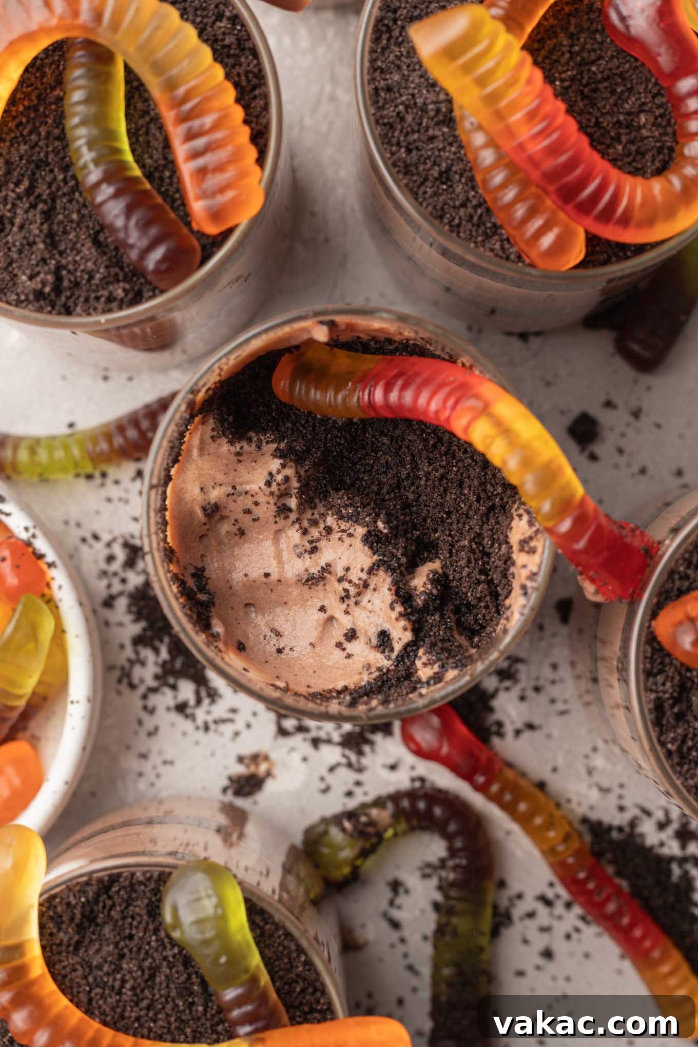 Sweet Soil Treats 12 An overhead view of multiple Oreo dirt pudding cups, beautifully layered and topped with gummy worms.