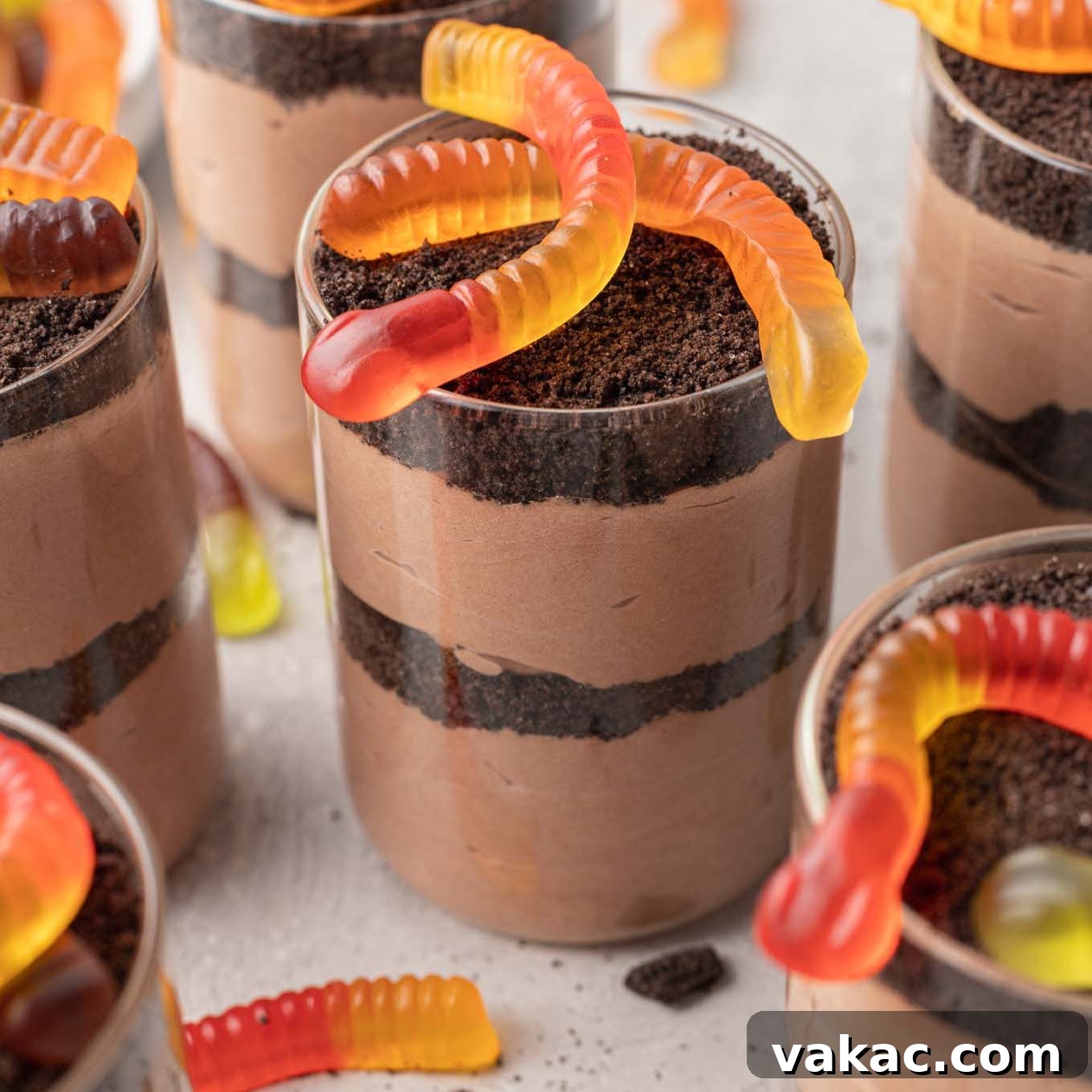 Several dirt cups topped with gummy worms, showcasing the finished dessert.