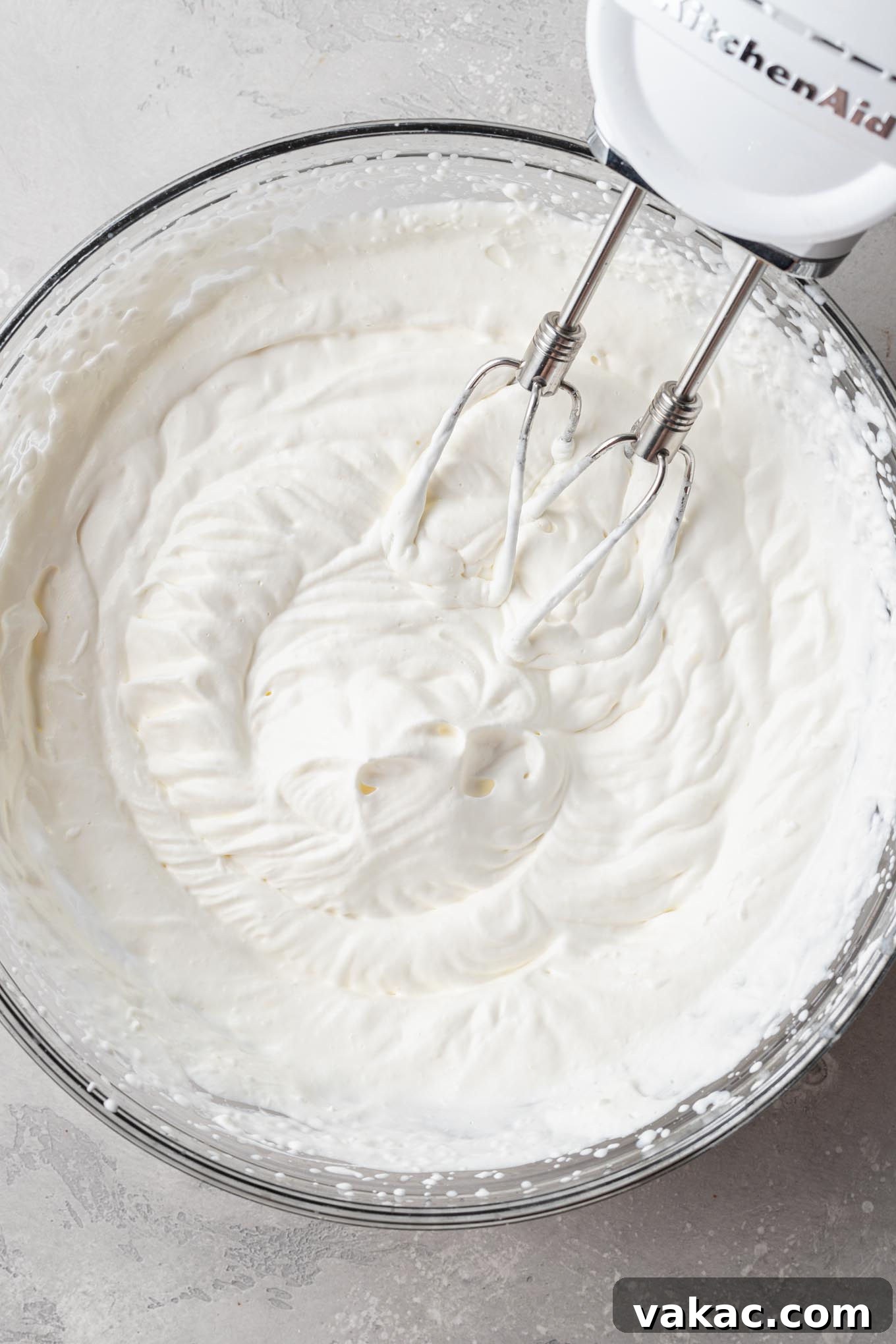 Sweet Soil Treats 6 An overhead view of heavy whipping cream being beaten to stiff peaks in a glass mixing bowl.