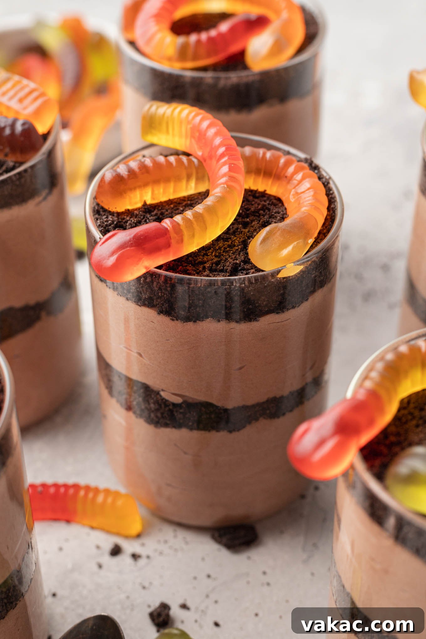 Sweet Soil Treats 10 Delicious dirt cups generously topped with classic gummy worms, ready to serve.