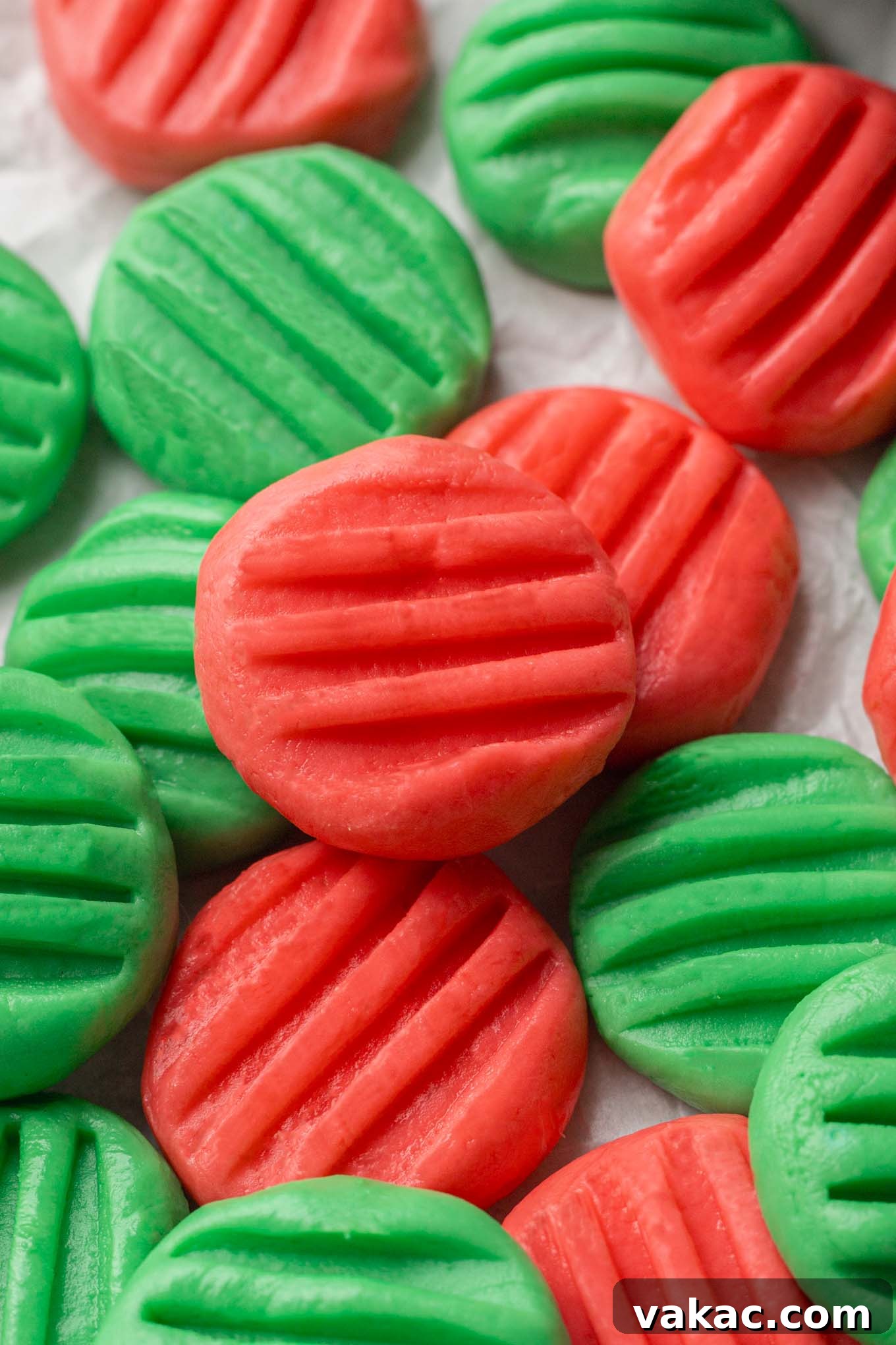 A close-up view of festive homemade wedding mints, dyed in classic red and green, perfectly formed and ready for holiday celebrations.