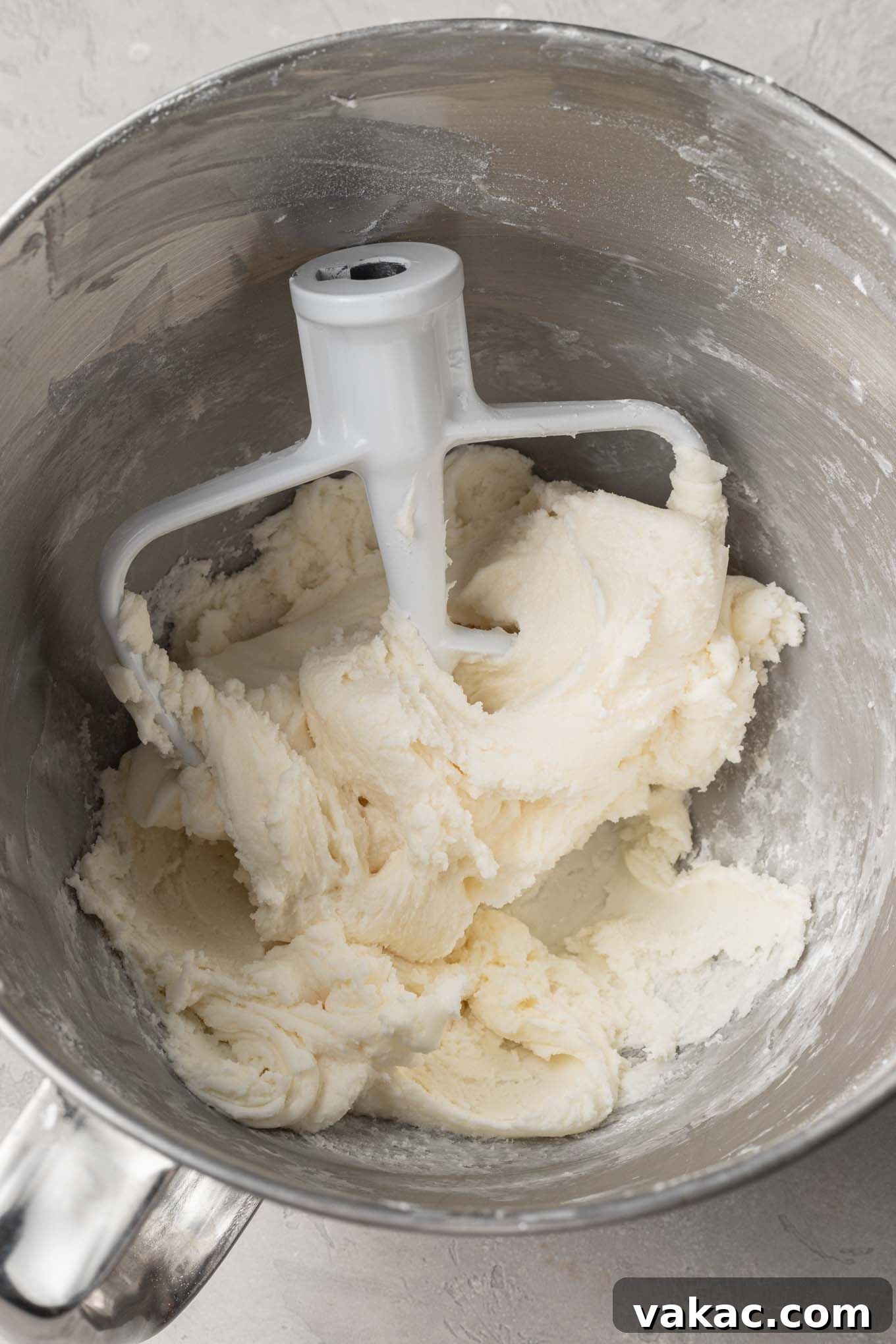 An overhead view of the fully mixed cream cheese mint mixture in a mixing bowl, showcasing its smooth, dense consistency, ready for coloring.