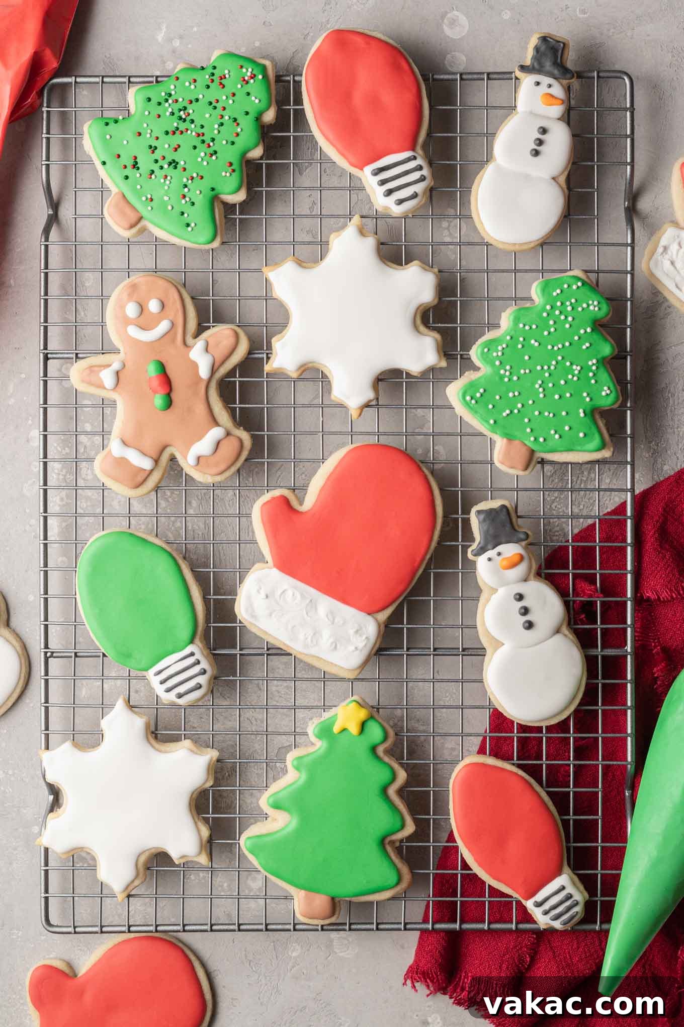 An overhead view of Christmas shaped sugar cookies decorated with royal icing.