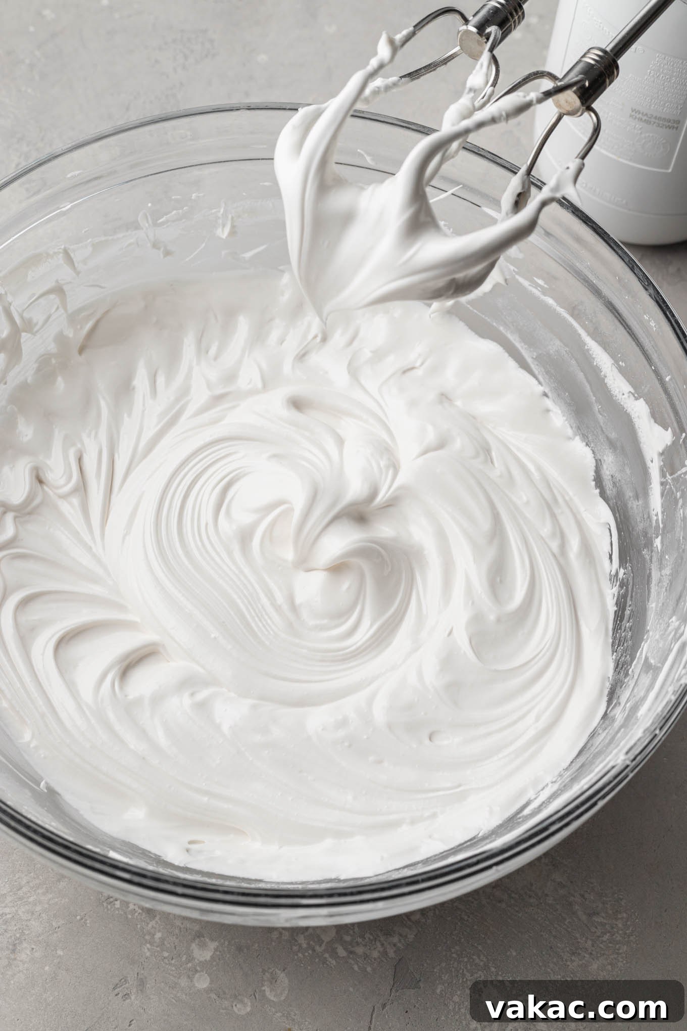 A bowl of royal icing beat to soft peaks.