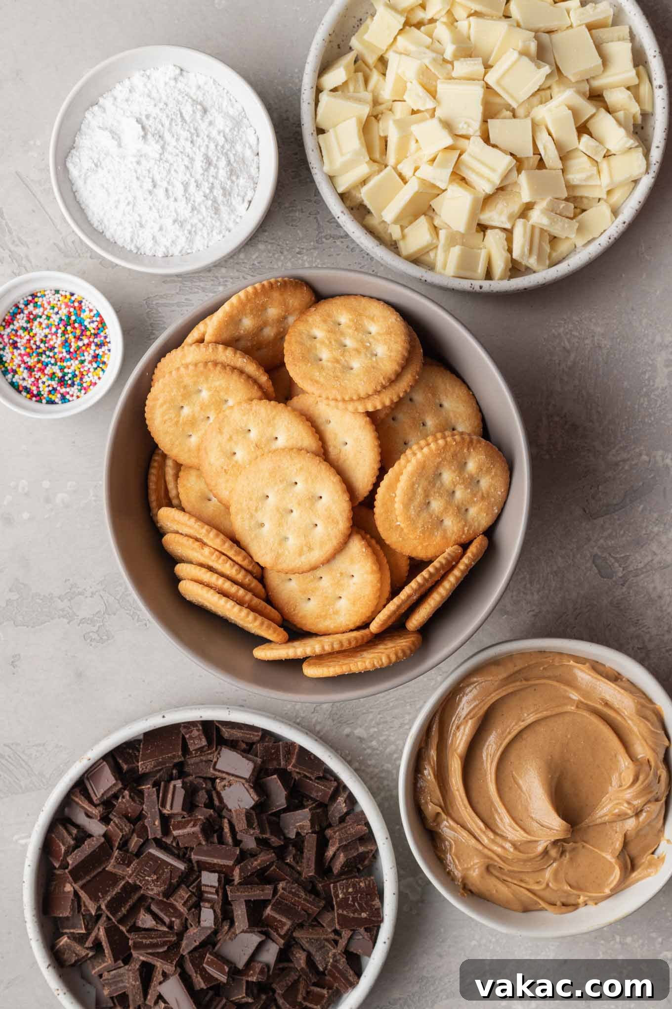 Golden Ritz Delights 3 An overhead view of the essential ingredients for making Ritz cookies: Ritz crackers, peanut butter, powdered sugar, and chocolate.