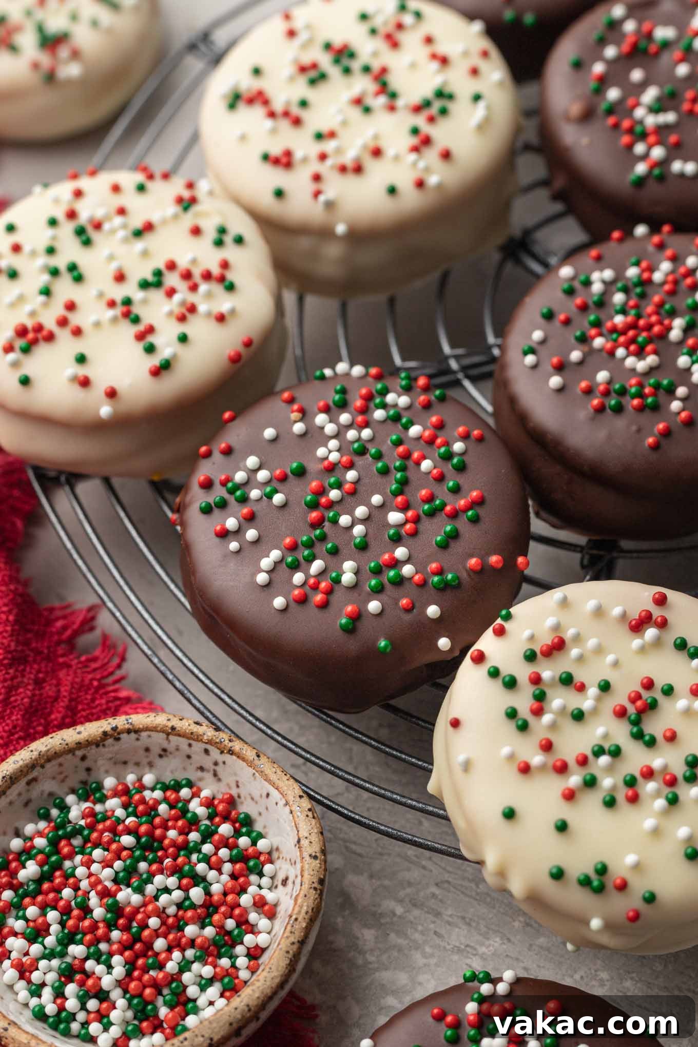 Golden Ritz Delights 10 A close-up view of perfectly chocolate-covered Ritz cookies, some with festive sprinkles, arranged on a wire cooling rack.