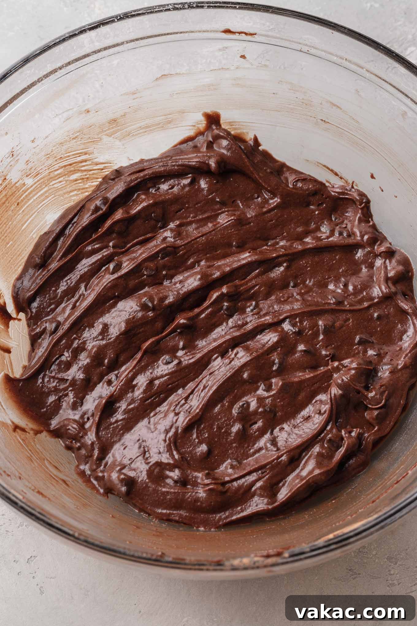 Bite-Sized Brownie Bliss 6 An overhead view of brownie batter in a glass mixing bowl.
