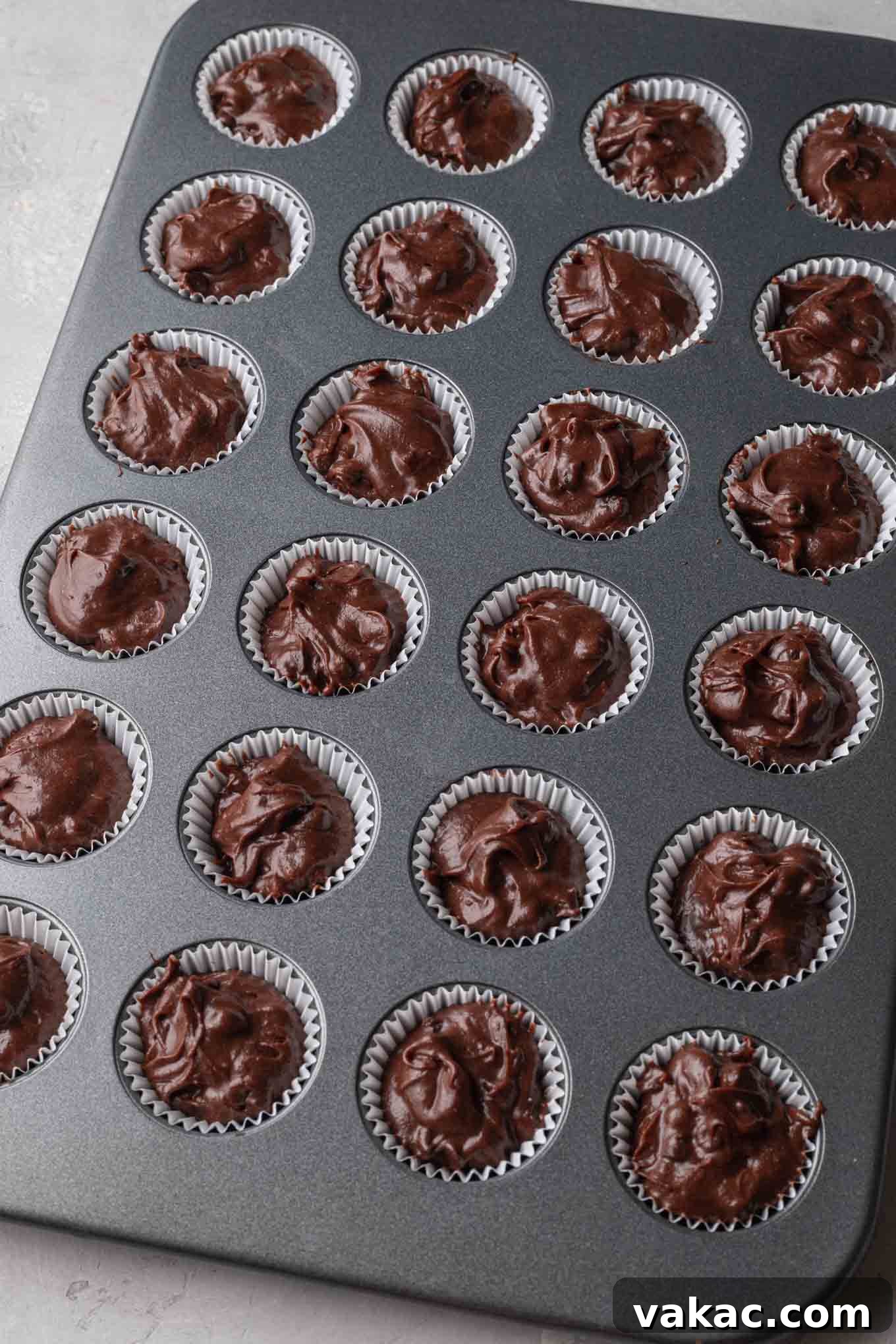 Bite-Sized Brownie Bliss 7 An overhead view of mini brownies in a mini muffin pan, ready to be baked.