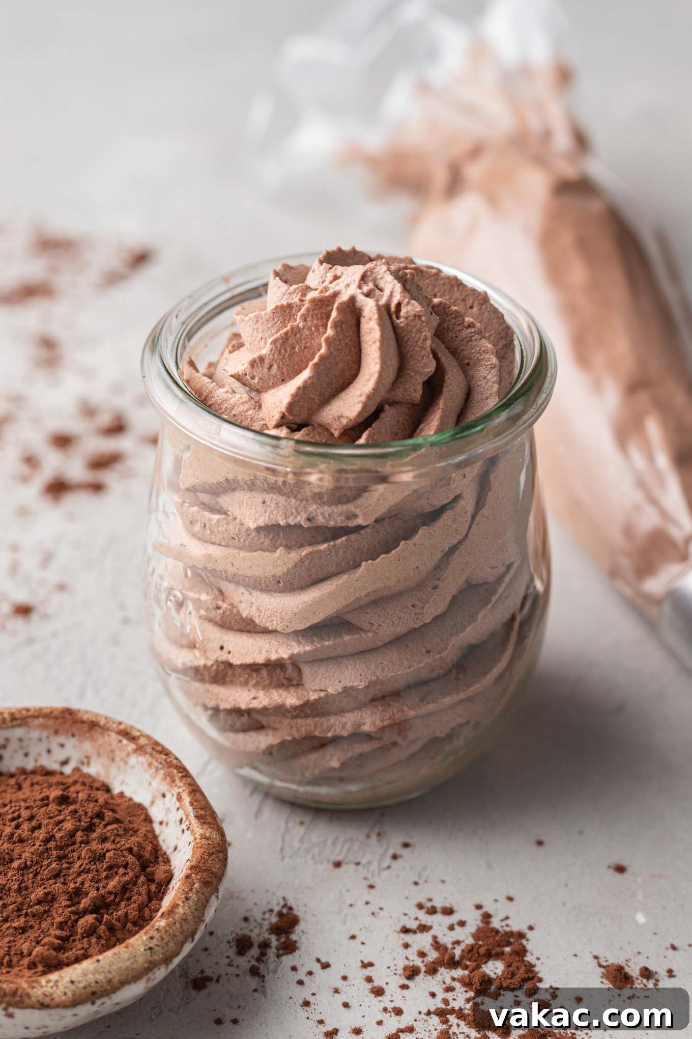 Velvet Chocolate Whip 2 A jar of chocolate whipped cream with a small bowl of Dutch process cocoa powder resting next to it.
