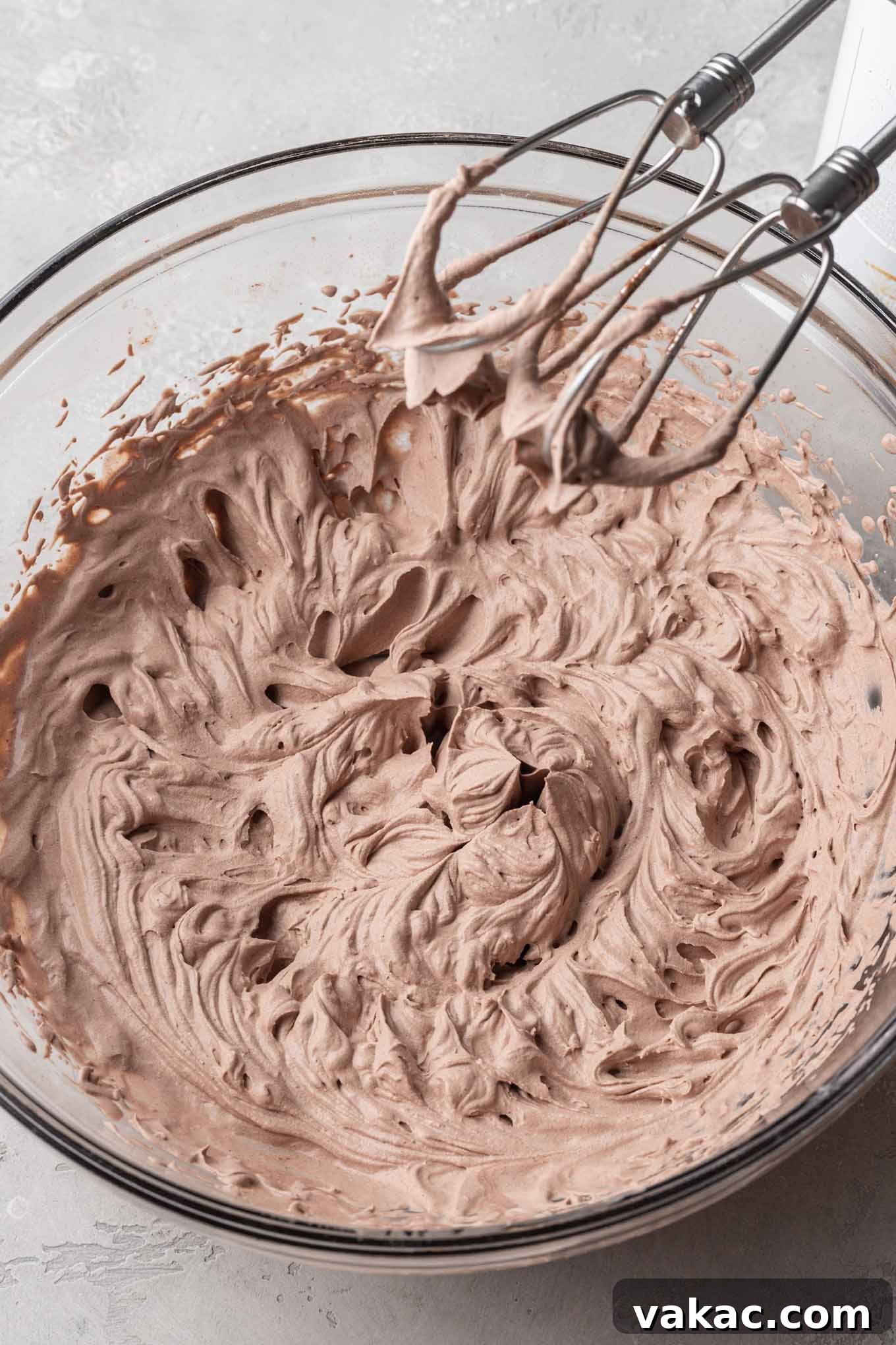 Velvet Chocolate Whip 6 A glass mixing bowl filled with the finished chocolate whipped cream.
