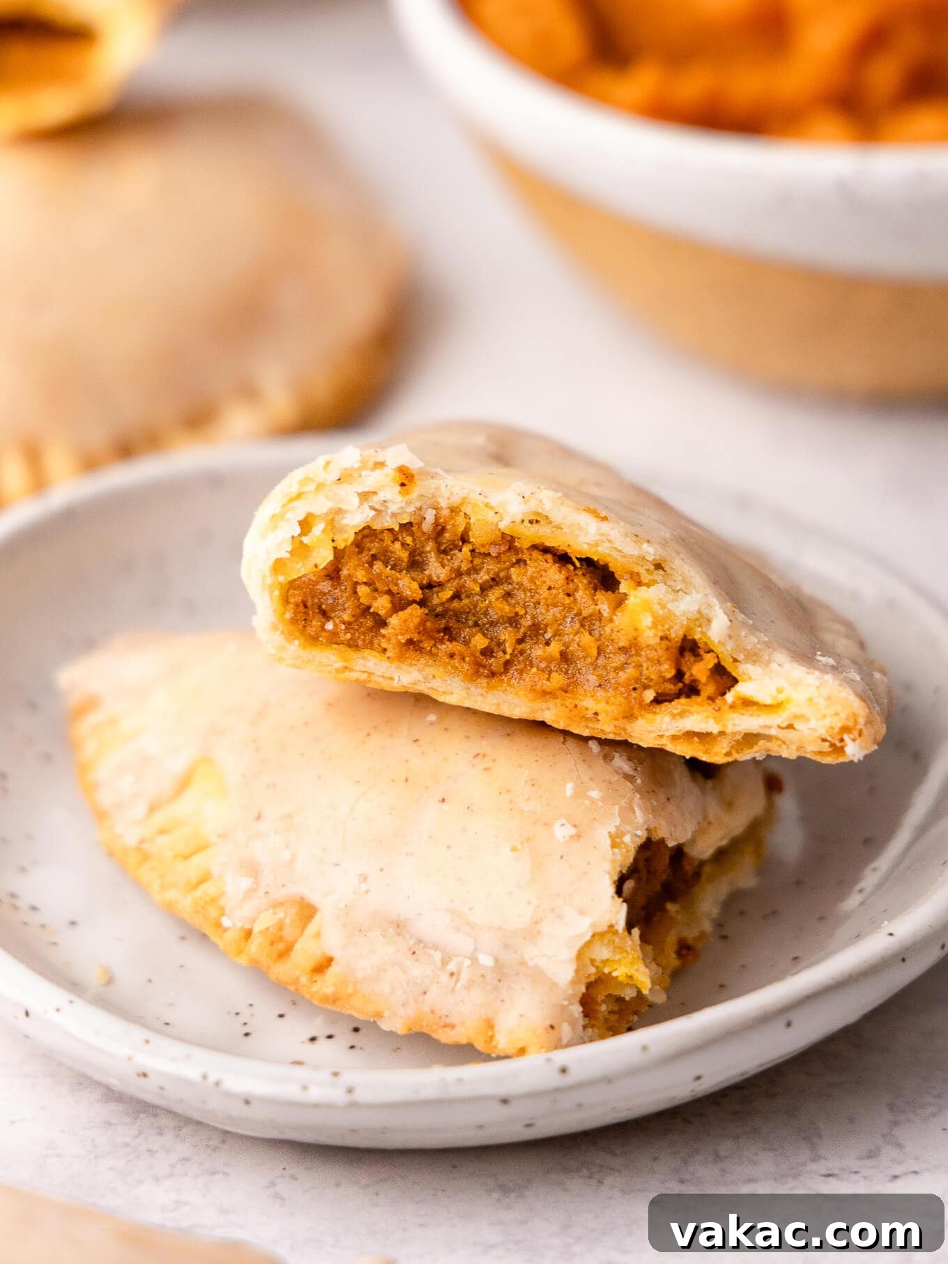 Autumn Pumpkin Pockets 2 A golden pumpkin hand pie, broken in half to reveal the spiced pumpkin filling.
