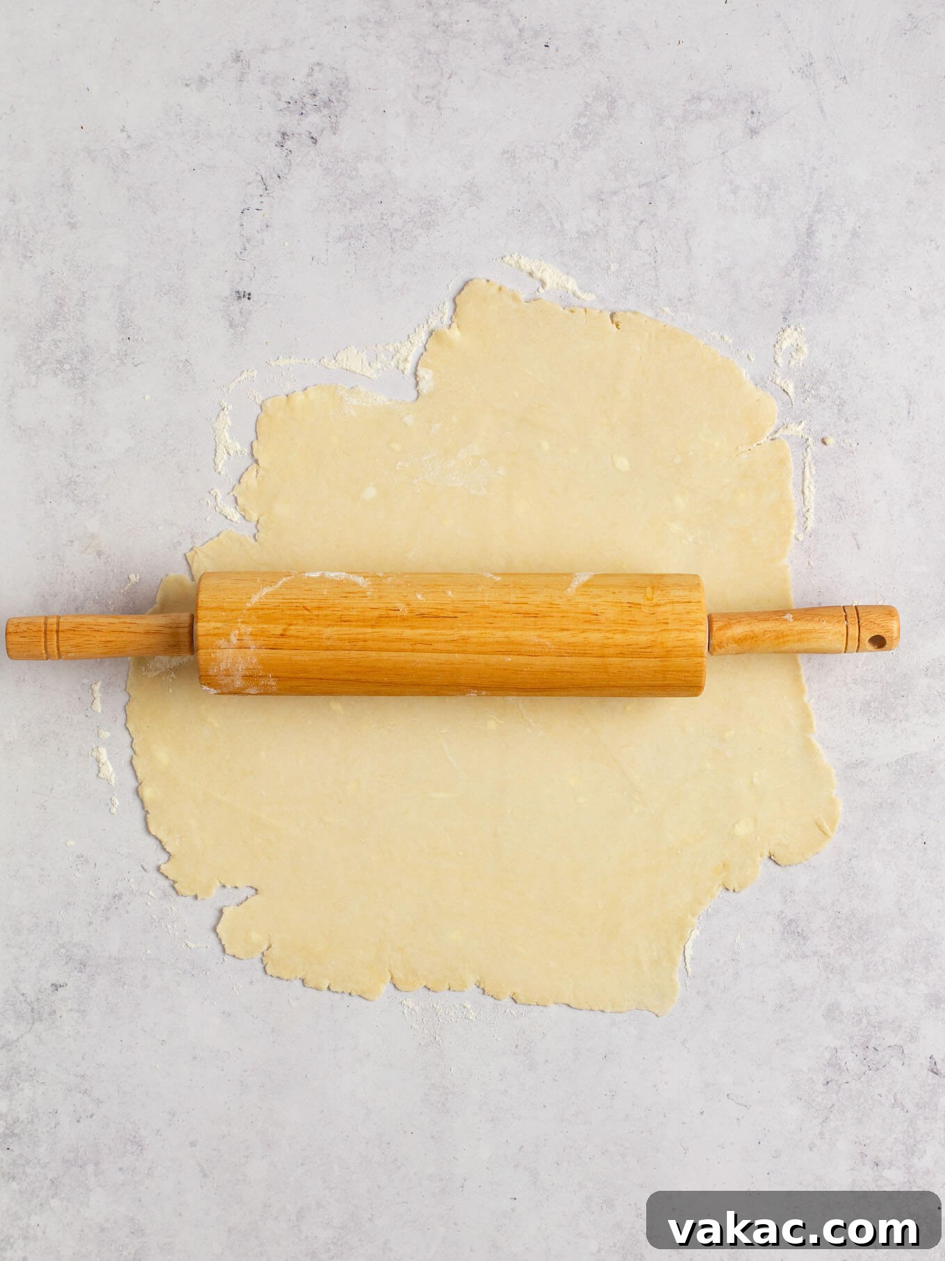 Autumn Pumpkin Pockets 4 Pie dough being carefully rolled out on a lightly floured surface, ready for cutting.