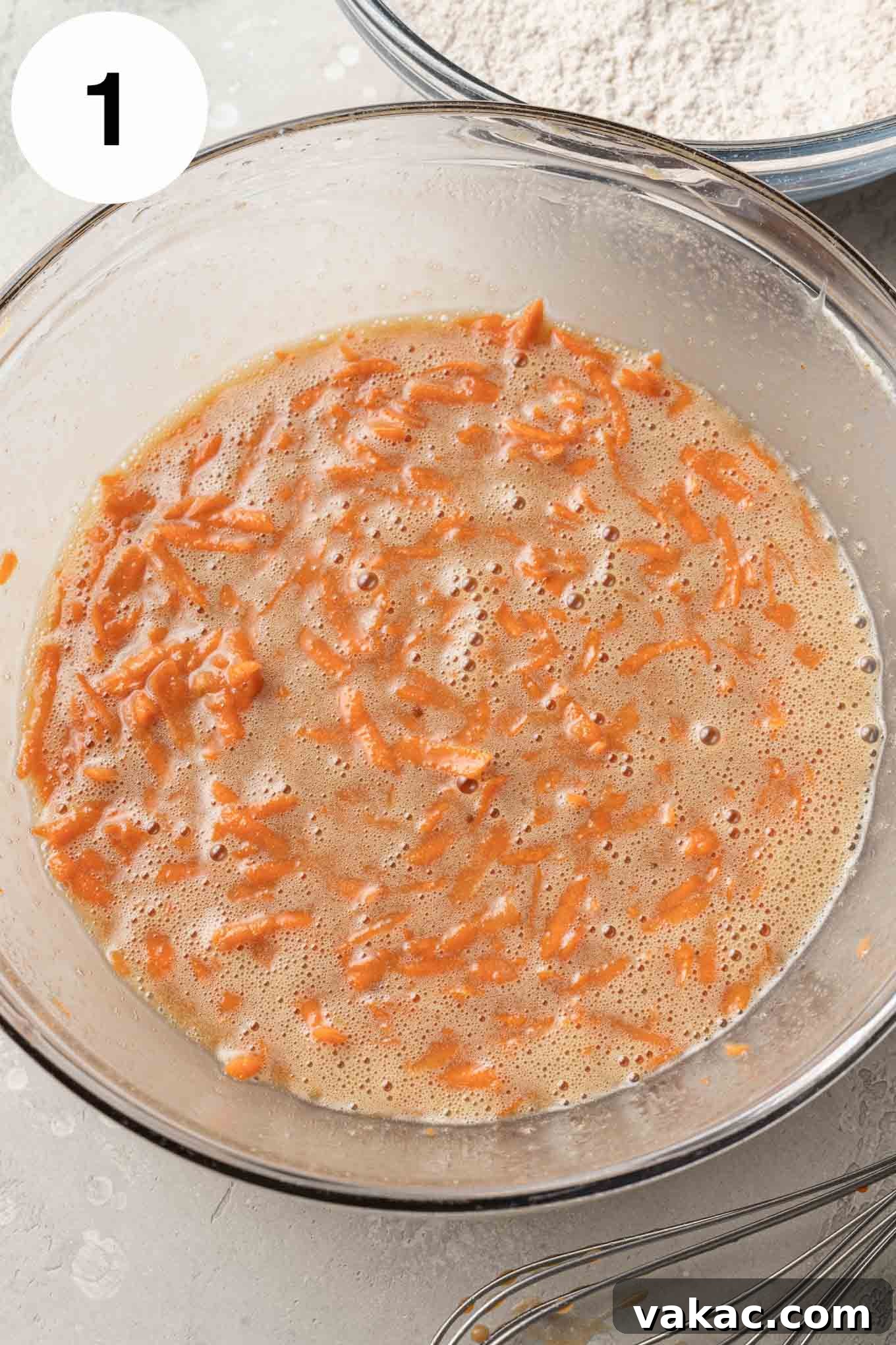 Decadent Spiced Carrot Cheesecake 4 An overhead view of the wet ingredients in a glass mixing bowl.