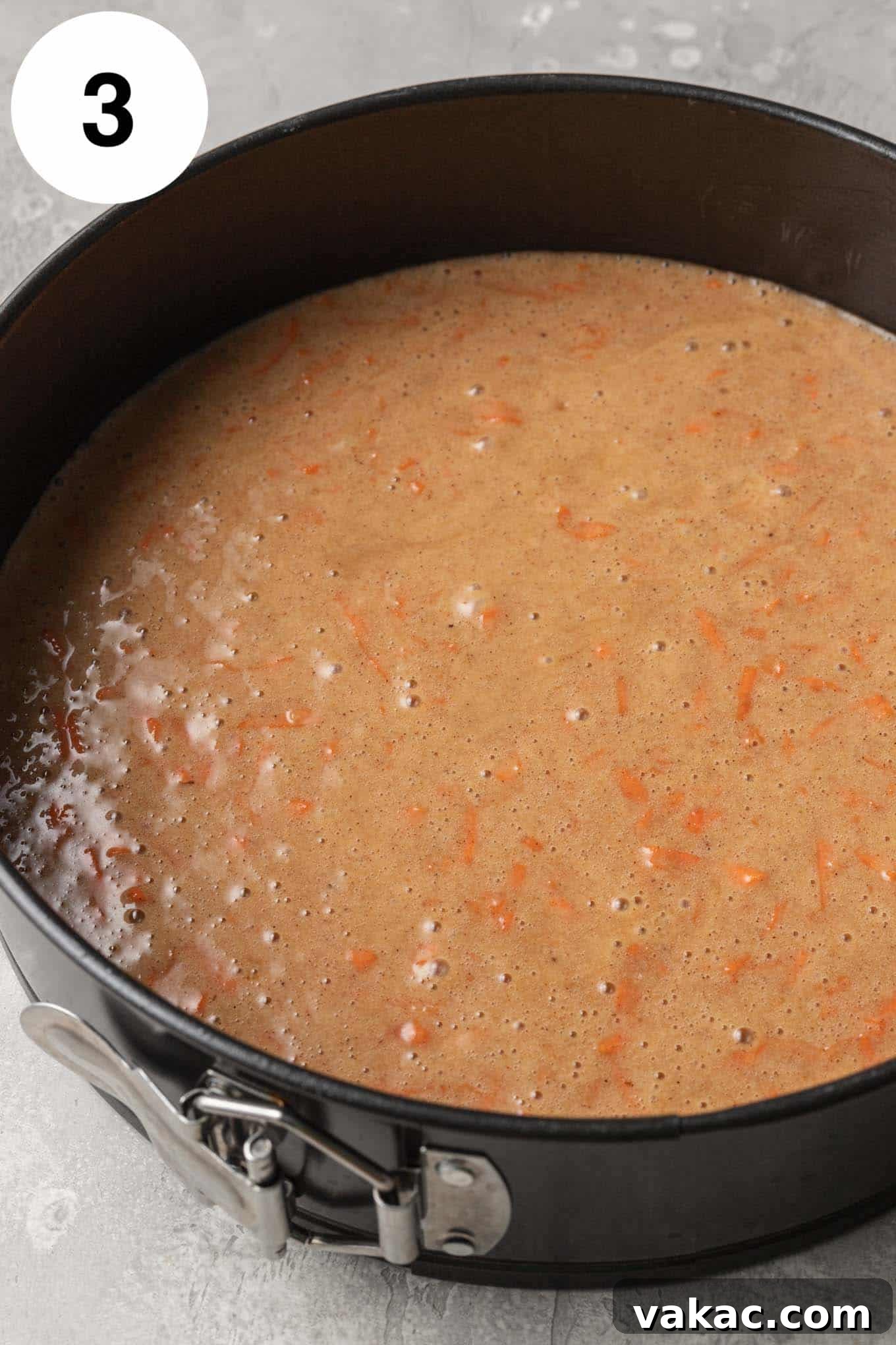Decadent Spiced Carrot Cheesecake 6 An overhead view of carrot cake batter in a springform pan.
