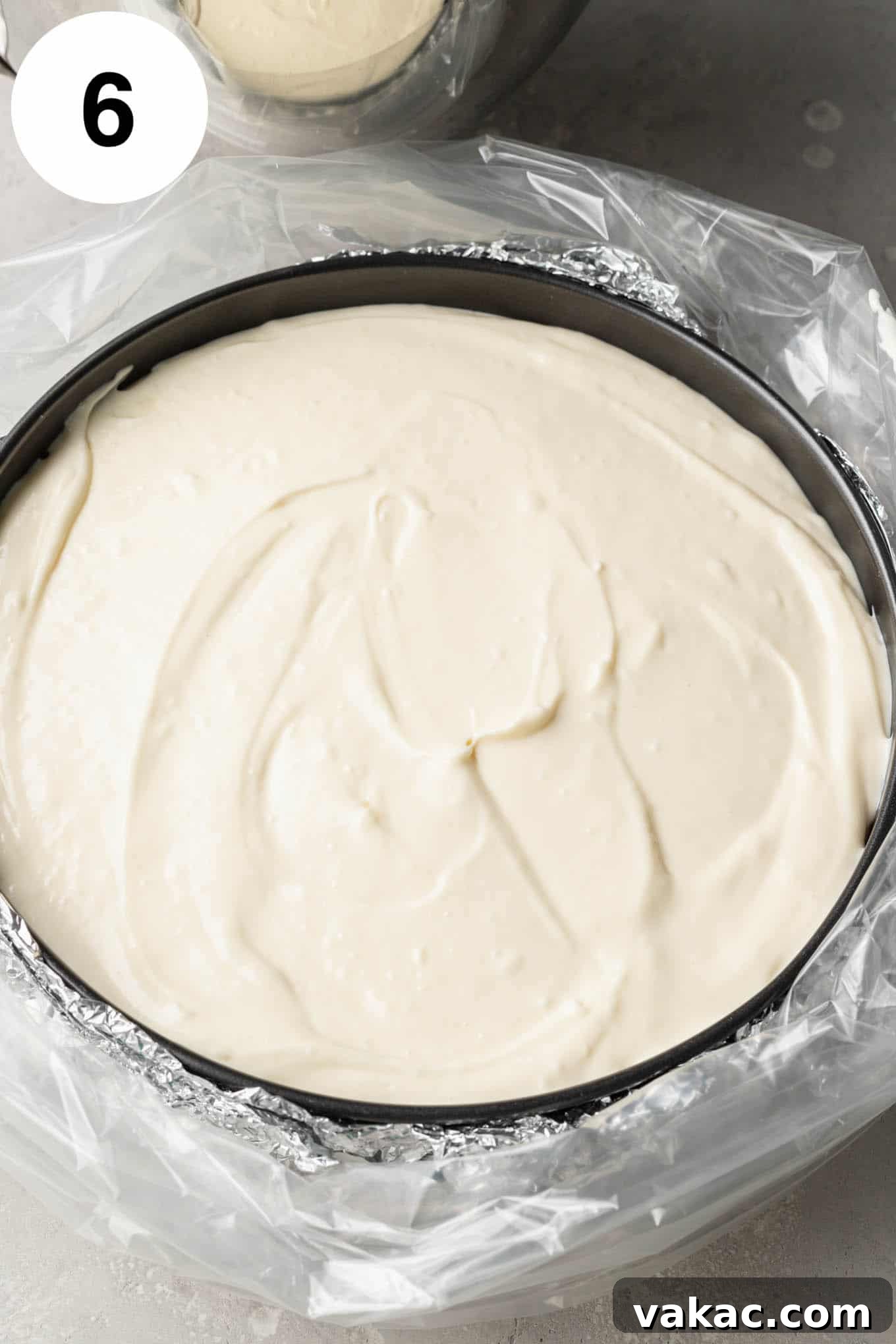 Decadent Spiced Carrot Cheesecake 9 An overhead view of an unbaked cheesecake in a springform pan, wrapped in foil and an oven bag.