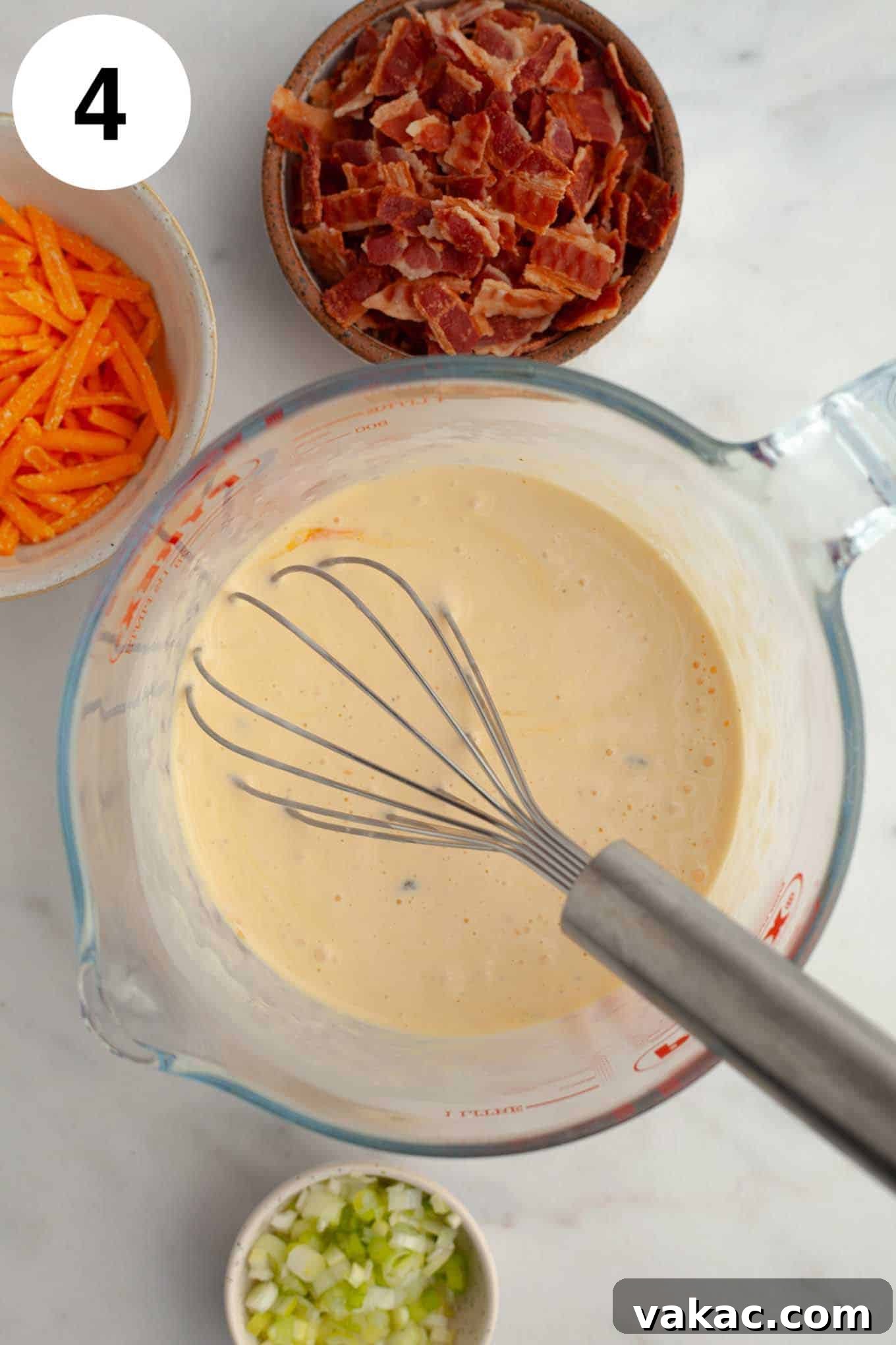 Bite-Sized Quiche Delights 7 An overhead view of the smoothly mixed mini quiche filling in a glass measuring cup, ready to be poured into the crusts.