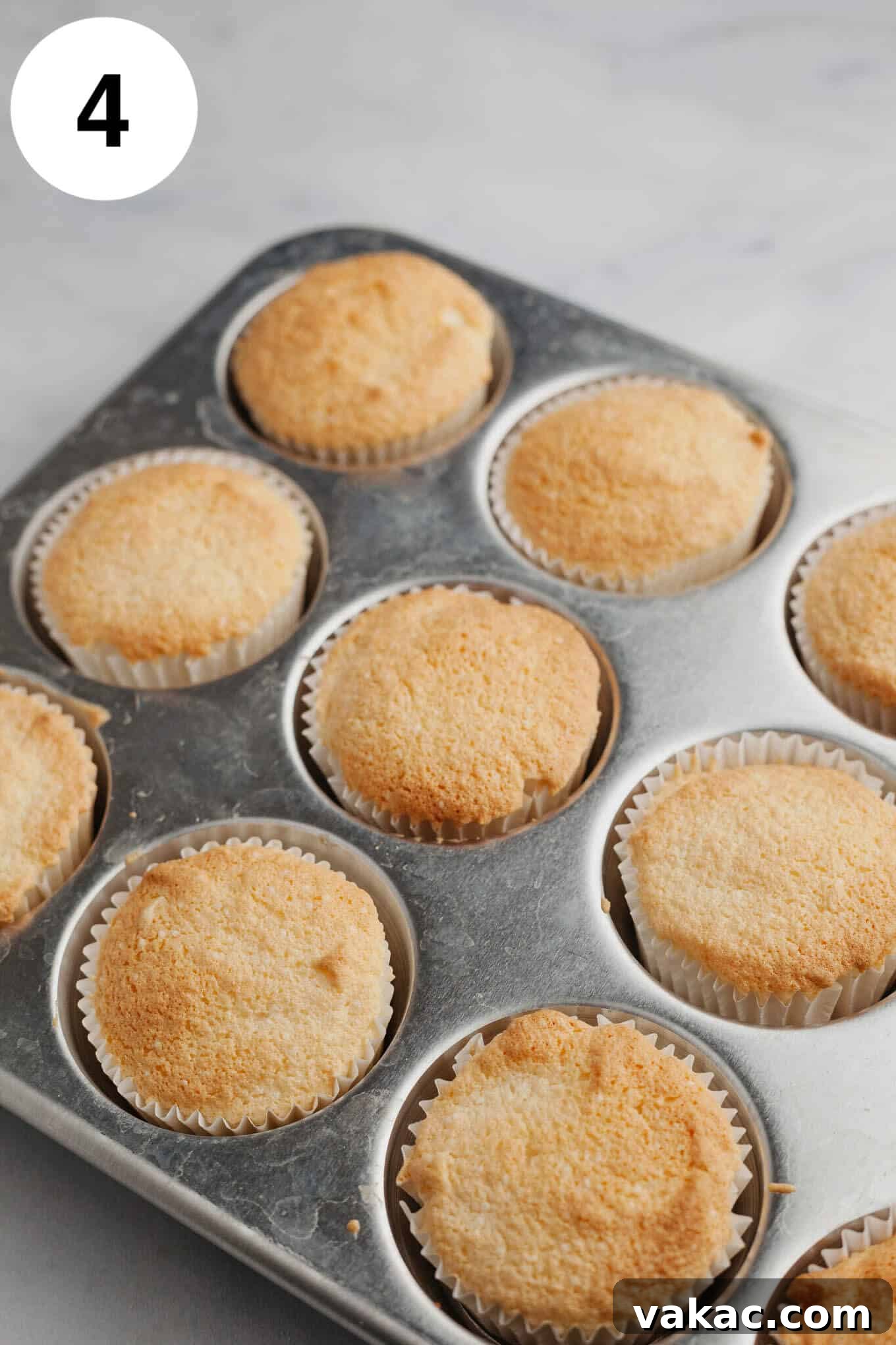 Cloud-Light Cupcakes 7 Unfrosted angel food cupcakes in a cupcake pan.