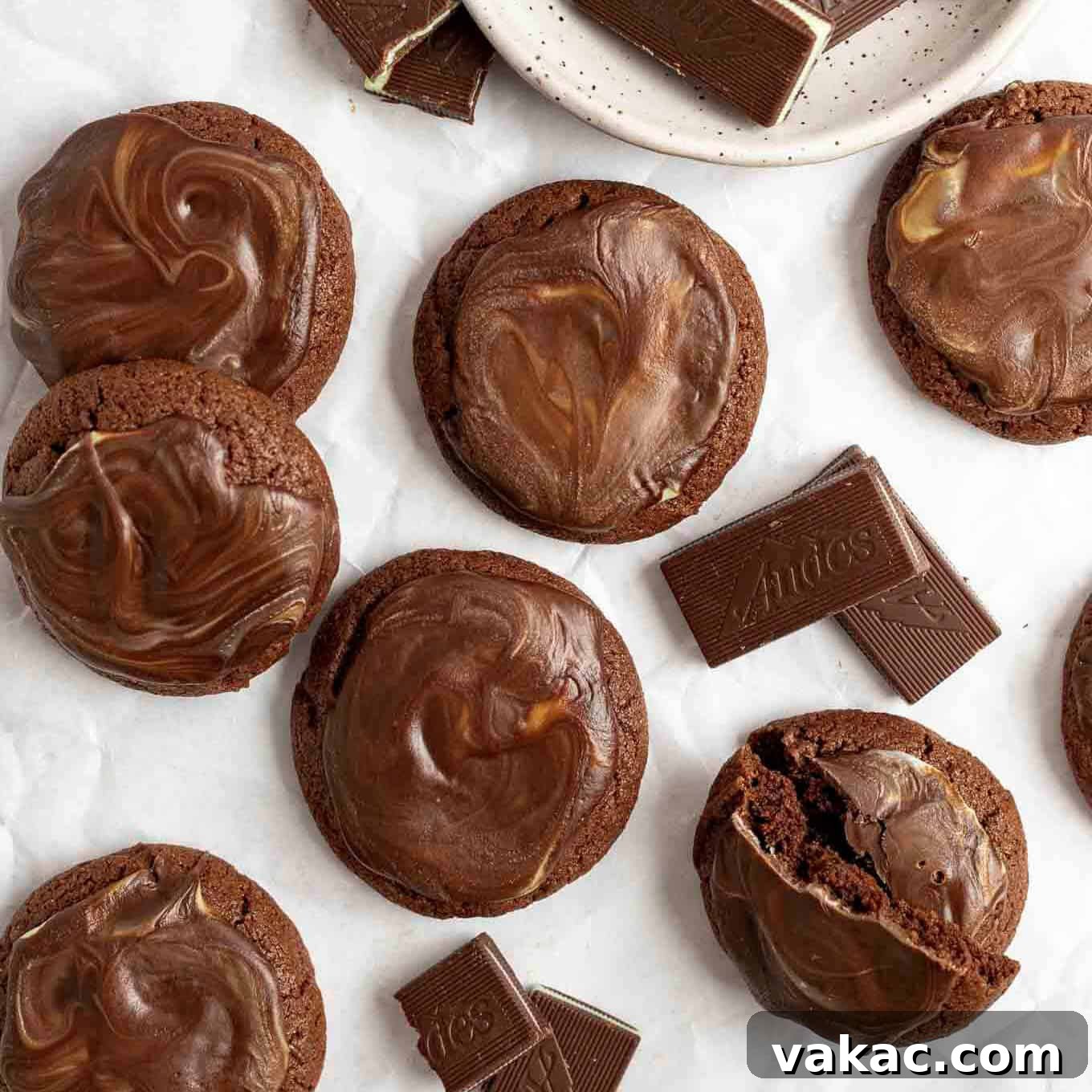 An overhead view of several Andes mint cookies spread out on a piece of parchment paper.
