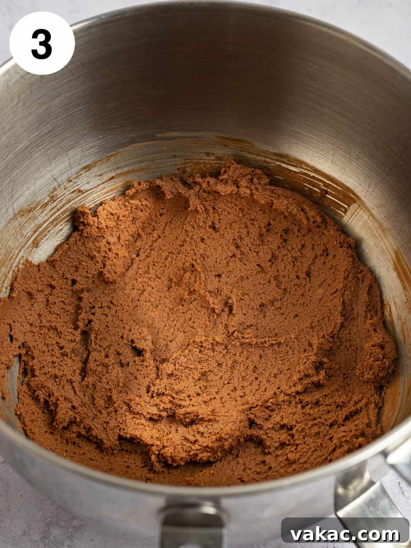 The perfectly mixed chocolate cookie dough resting in the bowl of a stand mixer, ready for chilling.