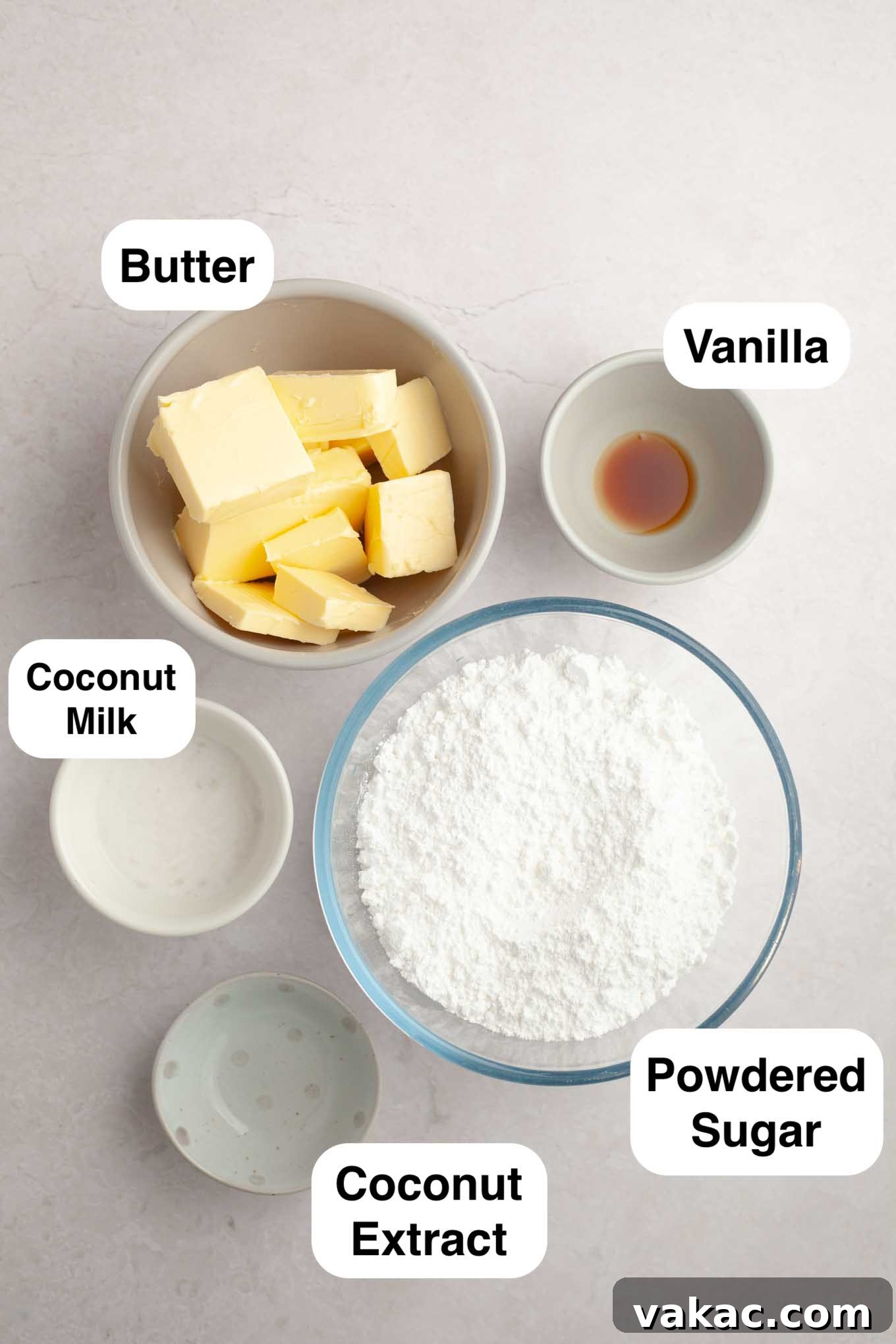 An inviting overhead view showcasing all the simple, fresh ingredients meticulously arranged for preparing a homemade coconut frosting, including butter, powdered sugar, and canned coconut milk.