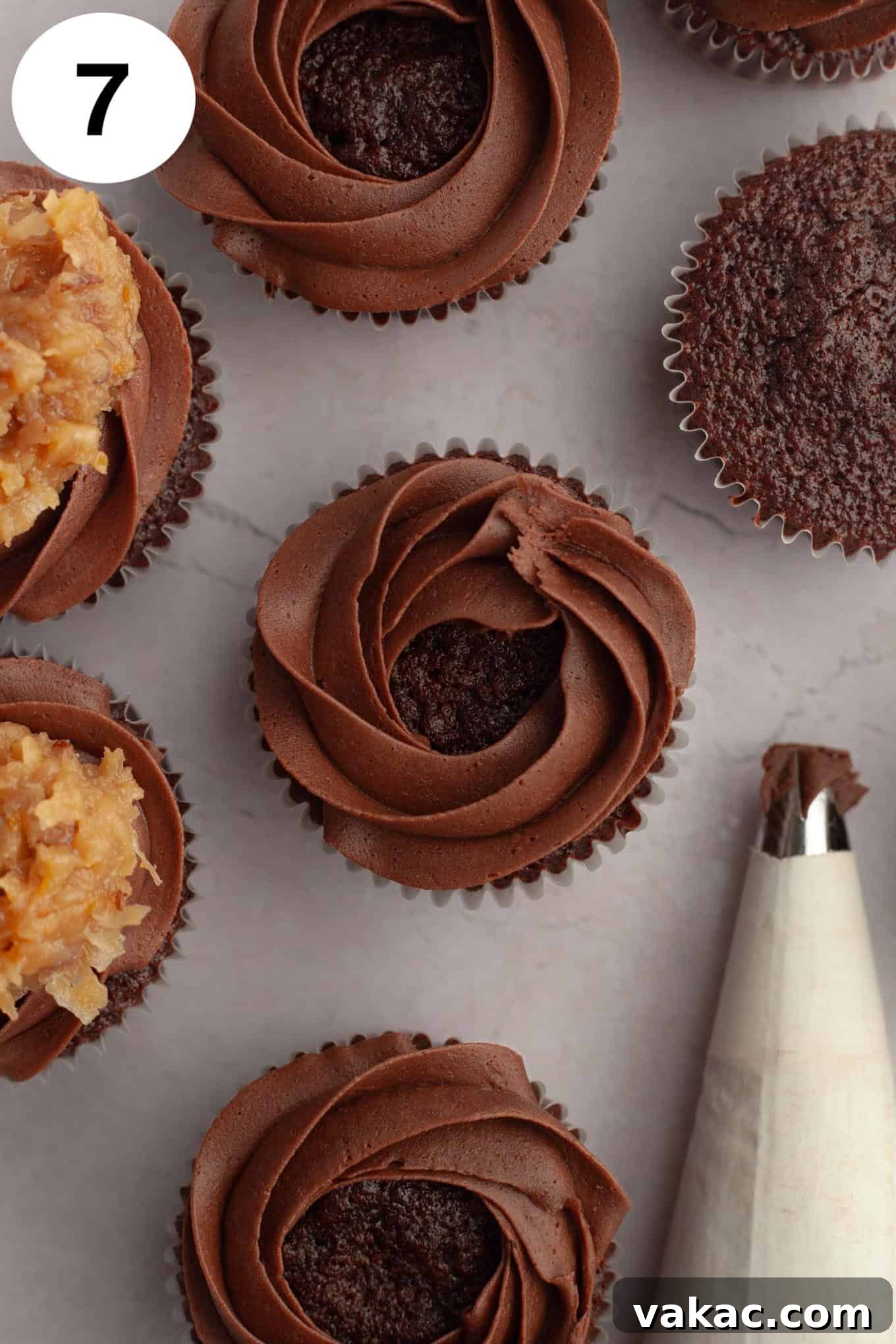 Ultimate German Chocolate Cupcakes 11 An overhead view of chocolate cupcakes with a border of chocolate frosting piped on top.