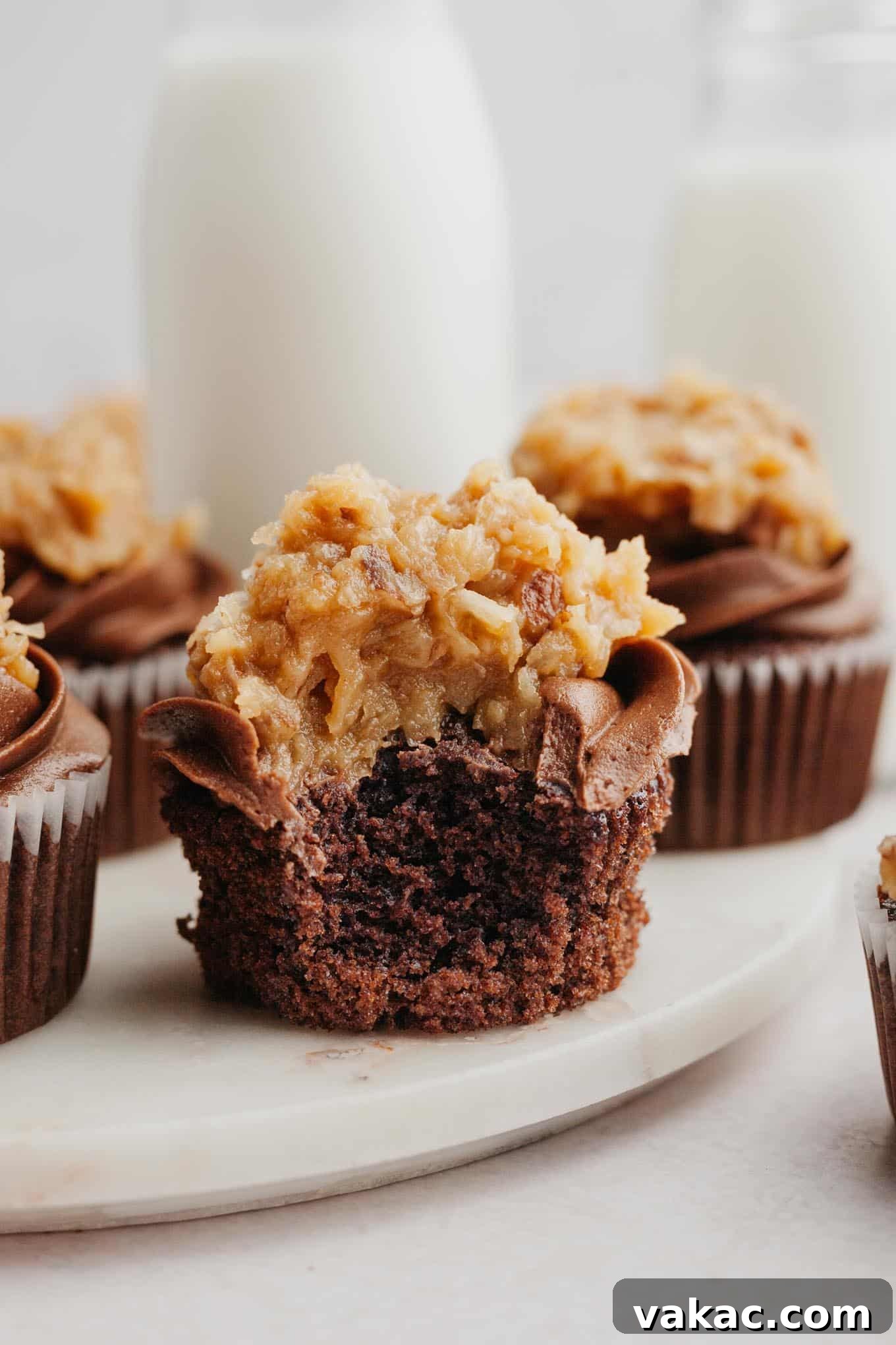 Ultimate German Chocolate Cupcakes 14 Frosted German chocolate cupcakes on a marble serving platter.