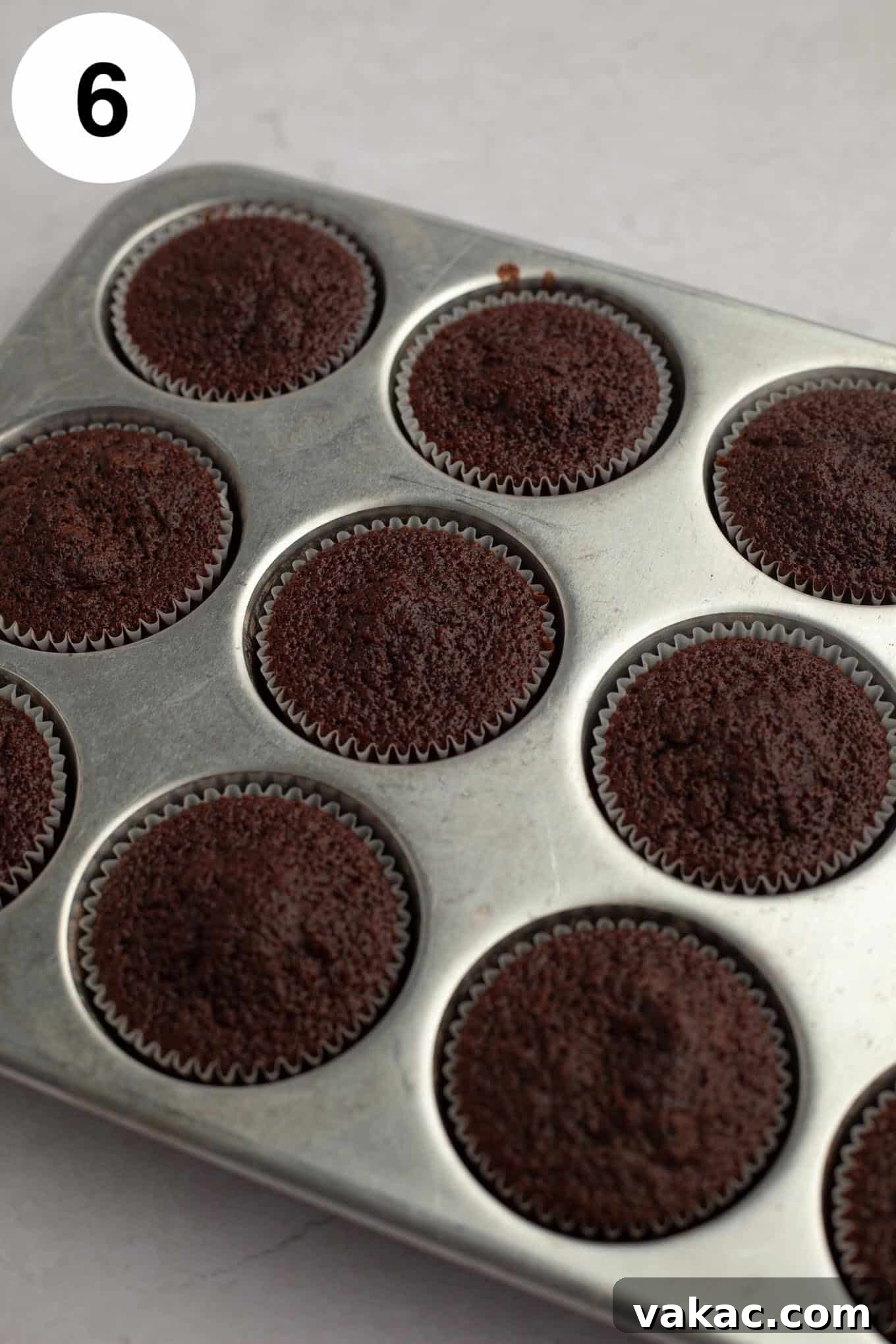 Ultimate German Chocolate Cupcakes 10 Baked chocolate cupcakes in a muffin pan.