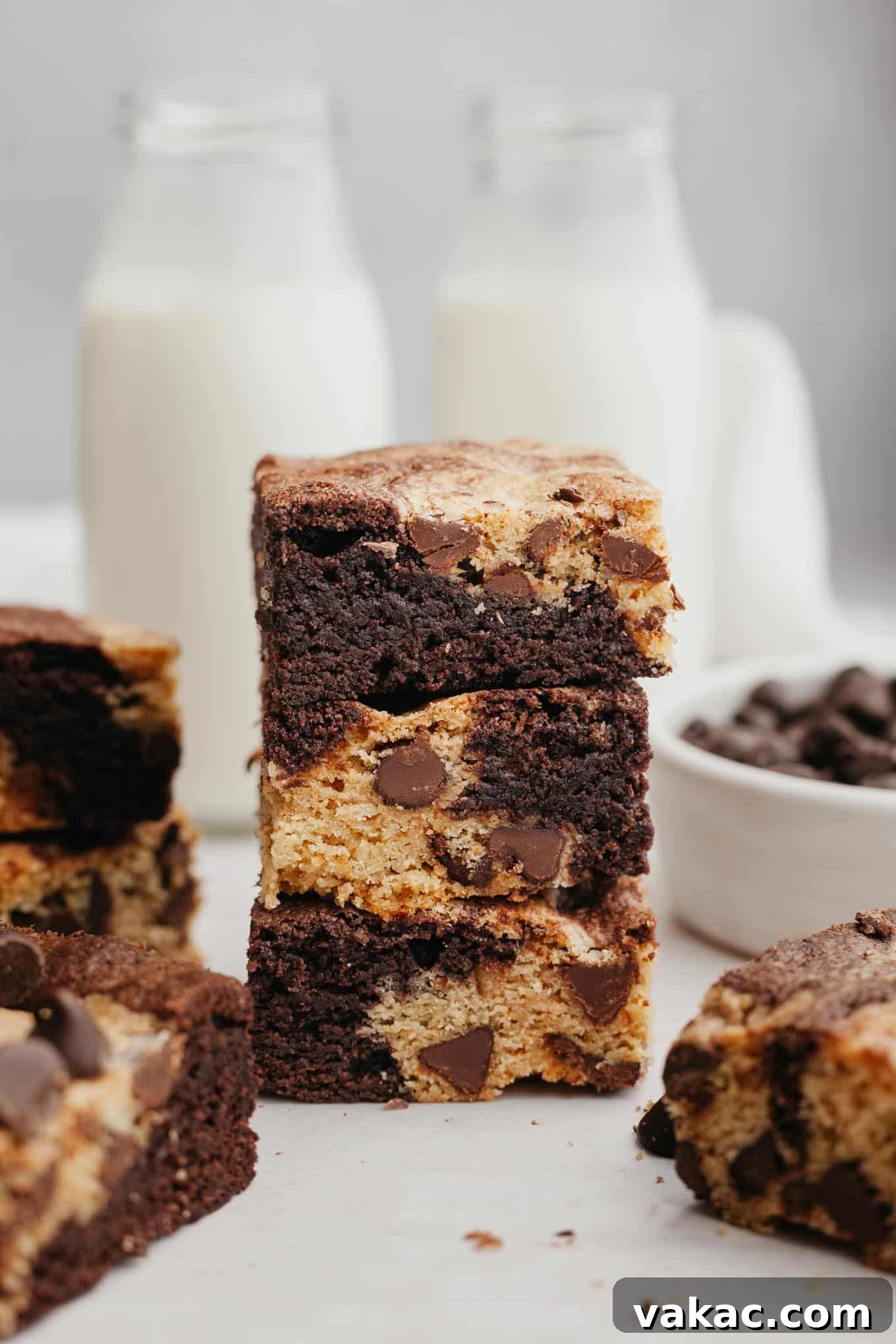 A stack of three brookies, with glass milk jugs in background. 