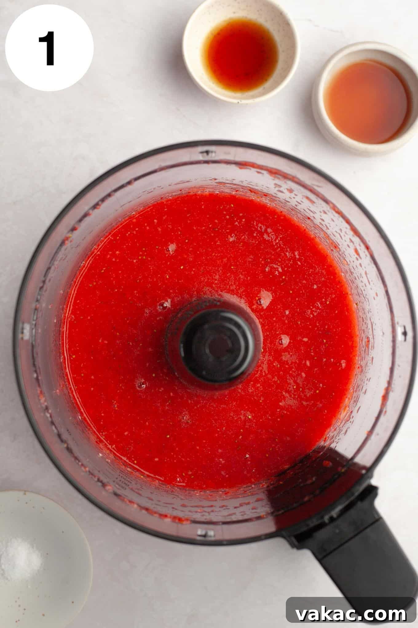 Strawberry Dream Cream 4 An overhead view of fresh strawberry puree being blended in a food processor, creating a smooth, vibrant red mixture.