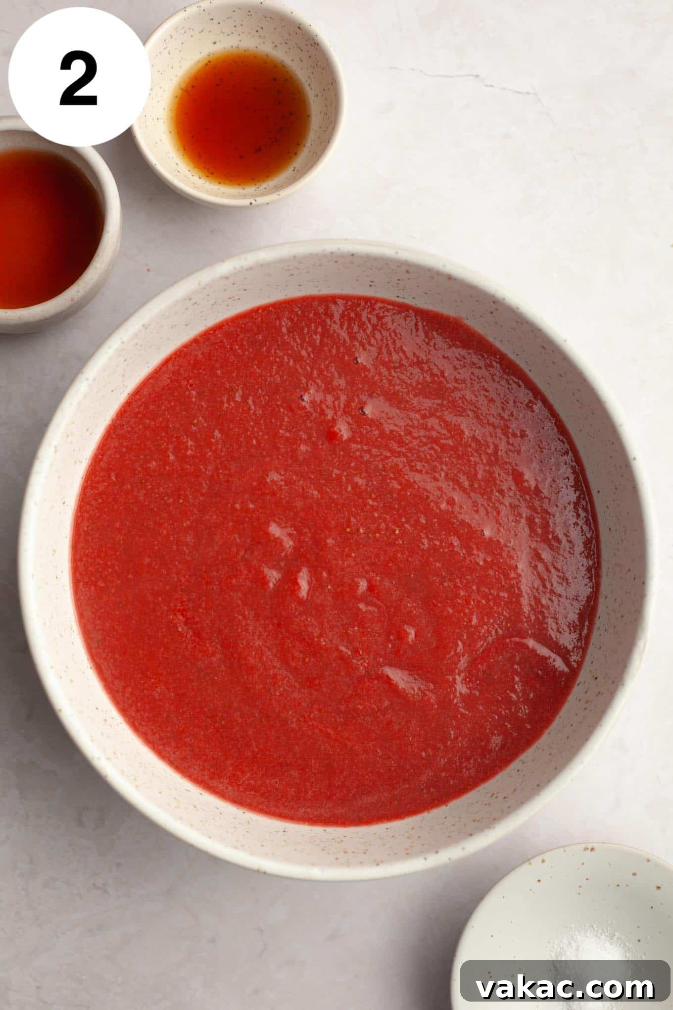 Strawberry Dream Cream 5 An overhead view of the reduced strawberry puree in a bowl, showcasing its deepened color and thicker consistency after cooking.