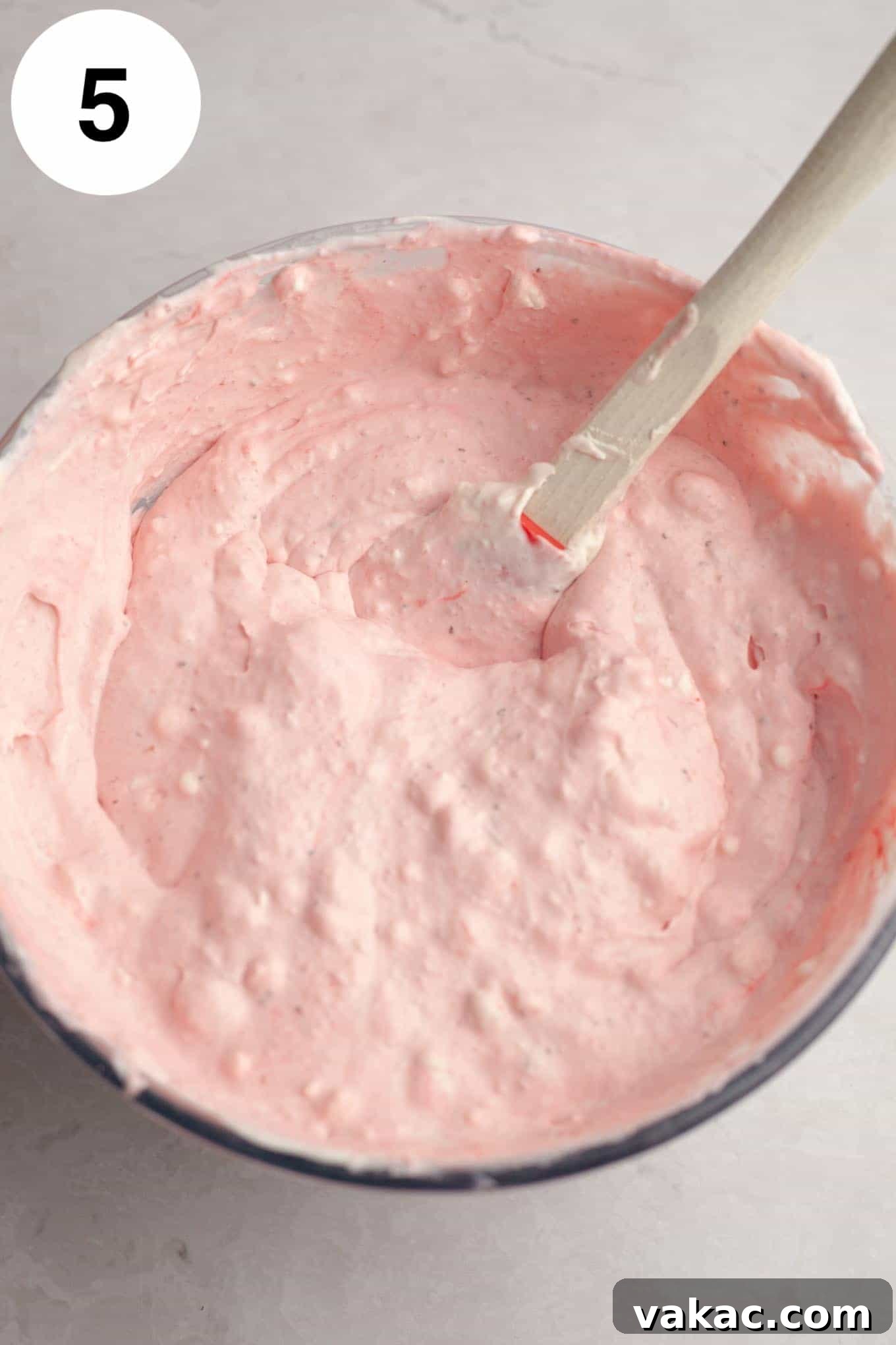 Strawberry Dream Cream 8 An overhead view of the creamy strawberry ice cream mixture in a large mixing bowl, showcasing its smooth, airy texture before freezing.