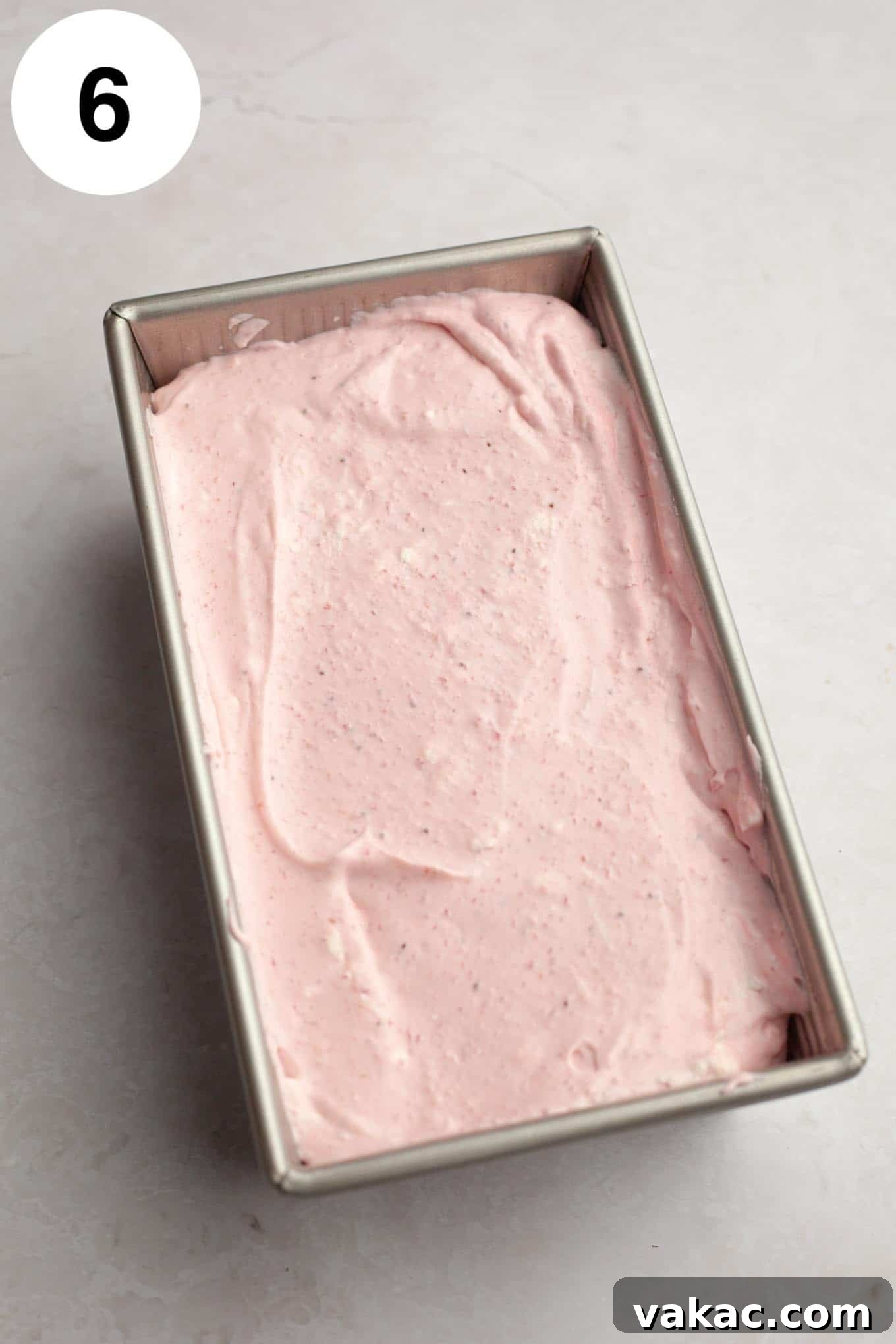 Strawberry Dream Cream 9 An overhead view of the strawberry ice cream mixture evenly spread into a metal loaf pan, ready for freezing.