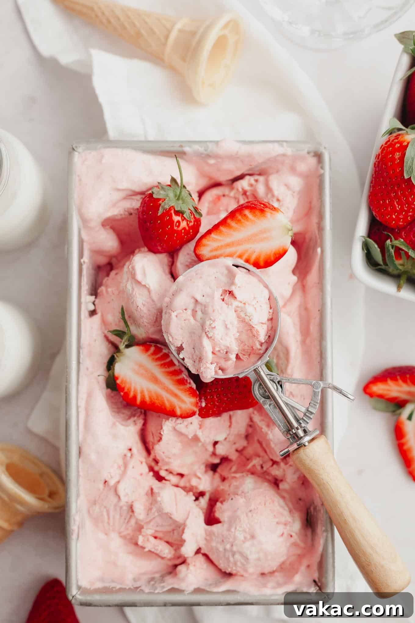 Strawberry Dream Cream 10 An overhead view of the finished strawberry ice cream in a metal loaf pan, beautifully garnished with fresh berries and ready to be served.