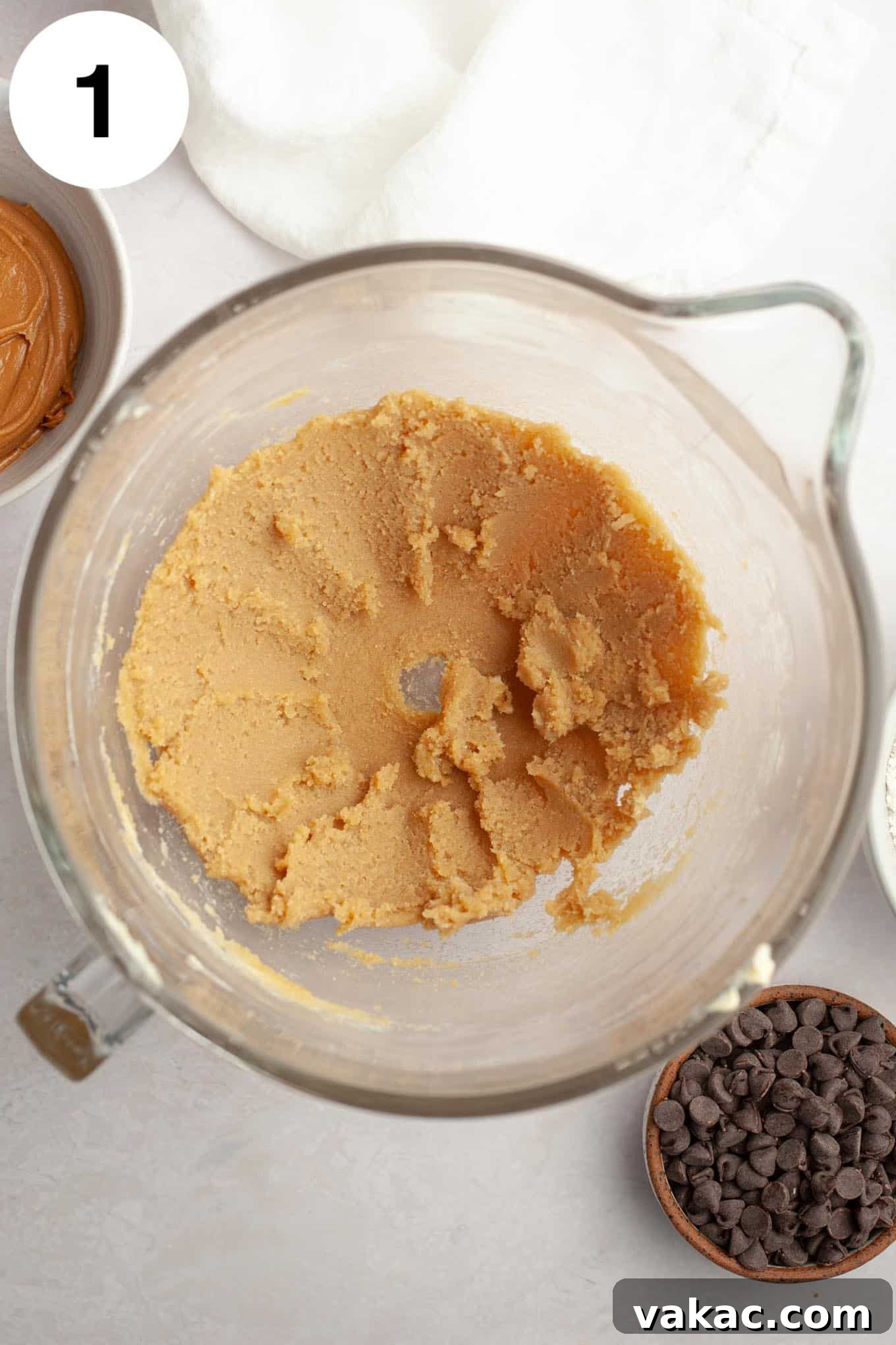 Peanut Butter Chocolate Bliss Bites 4 An overhead view illustrating the first step: butter and sugar perfectly creamed together in a clear glass mixing bowl, light and fluffy.