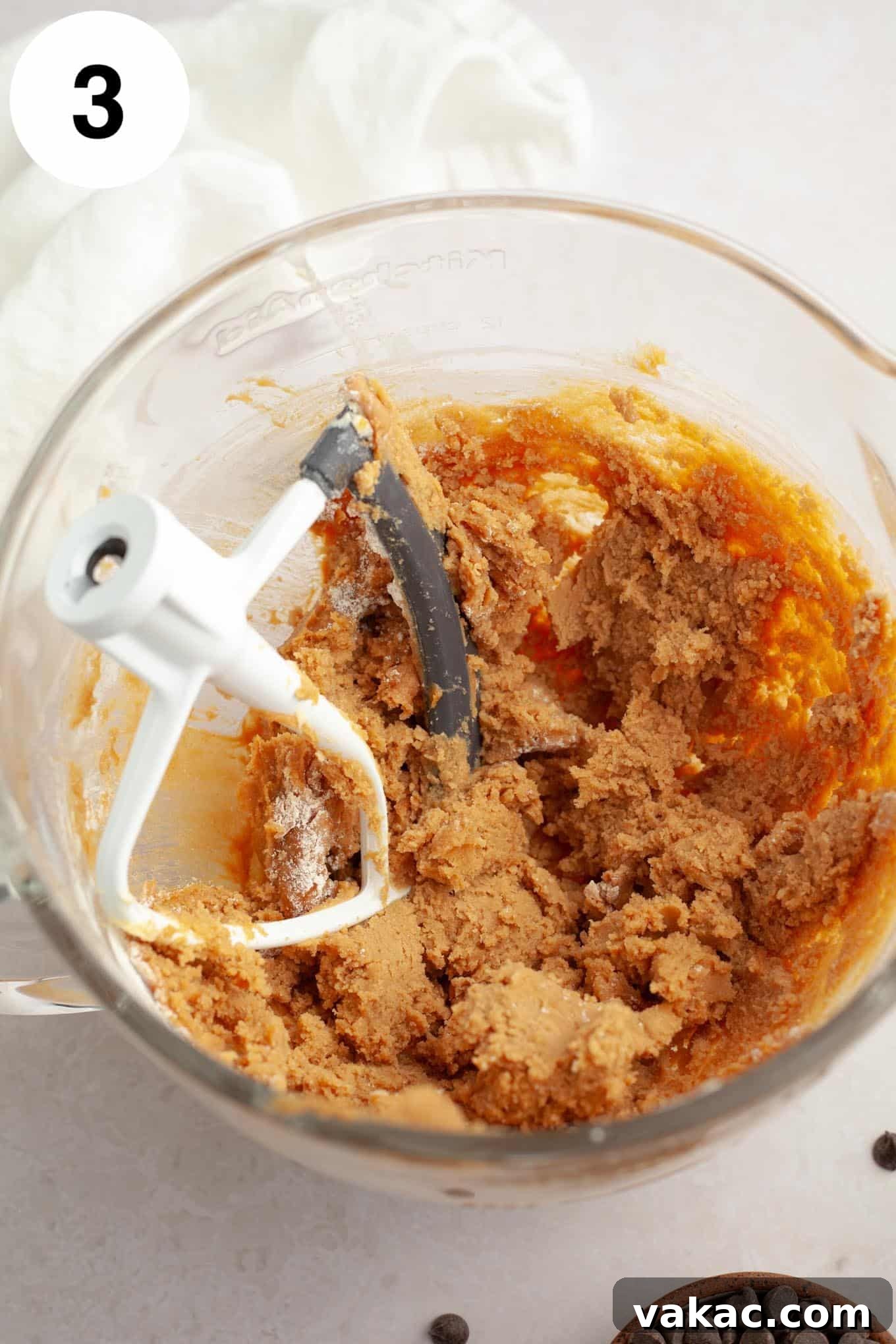 Peanut Butter Chocolate Bliss Bites 6 An overhead shot of perfectly mixed peanut butter cookie dough, smooth and ready for the final additions, resting in a glass mixing bowl.