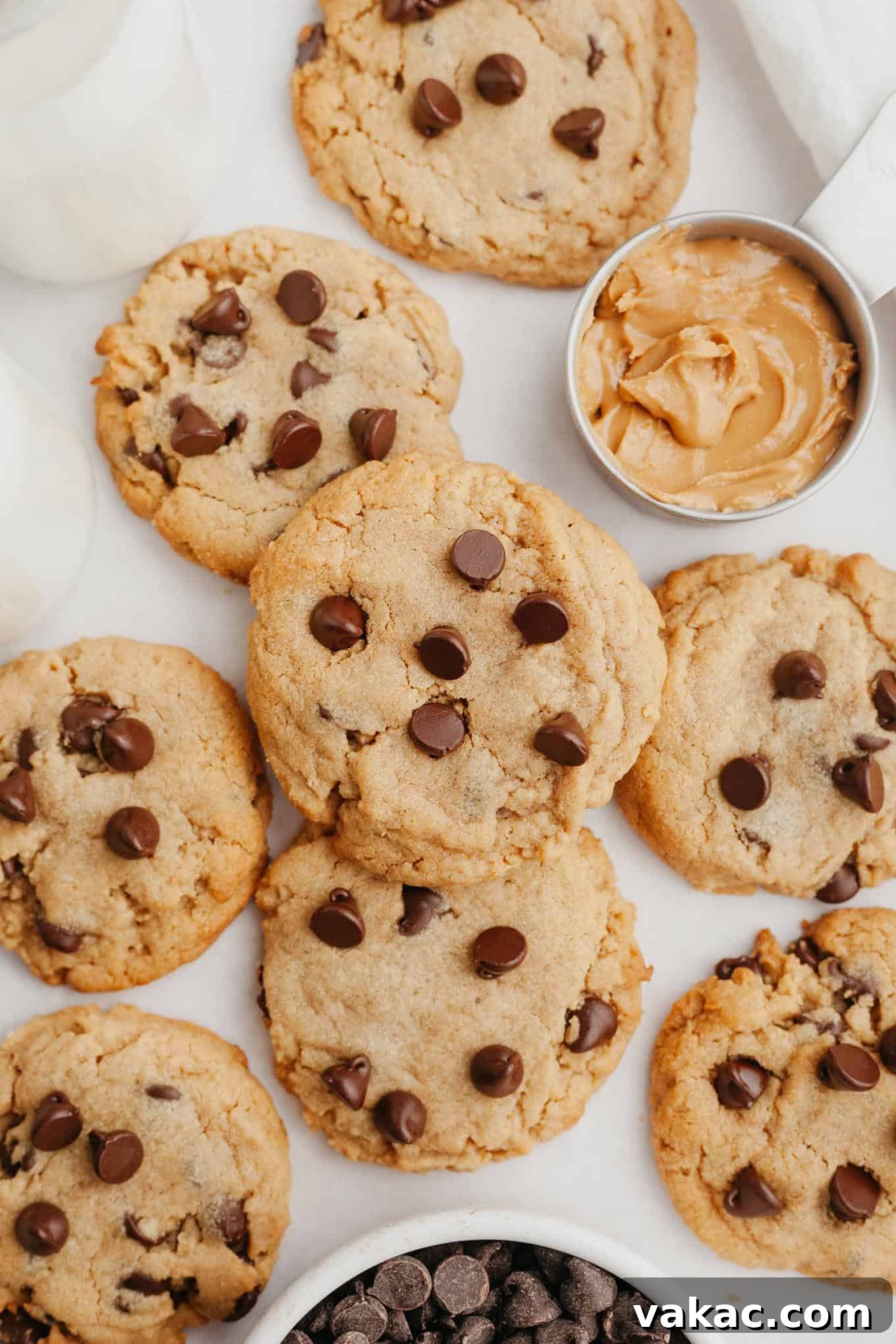 Peanut Butter Chocolate Bliss Bites 10 An overhead view of a generously piled platter of freshly baked peanut butter chocolate chip cookies, a tempting display of golden treats.