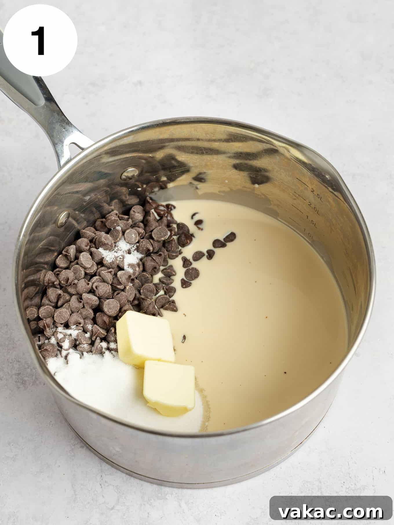 Decadent Homemade Hot Fudge Sauce 4 A metal saucepan full of evaporated milk, sugar, butter, salt, and chocolate chips.