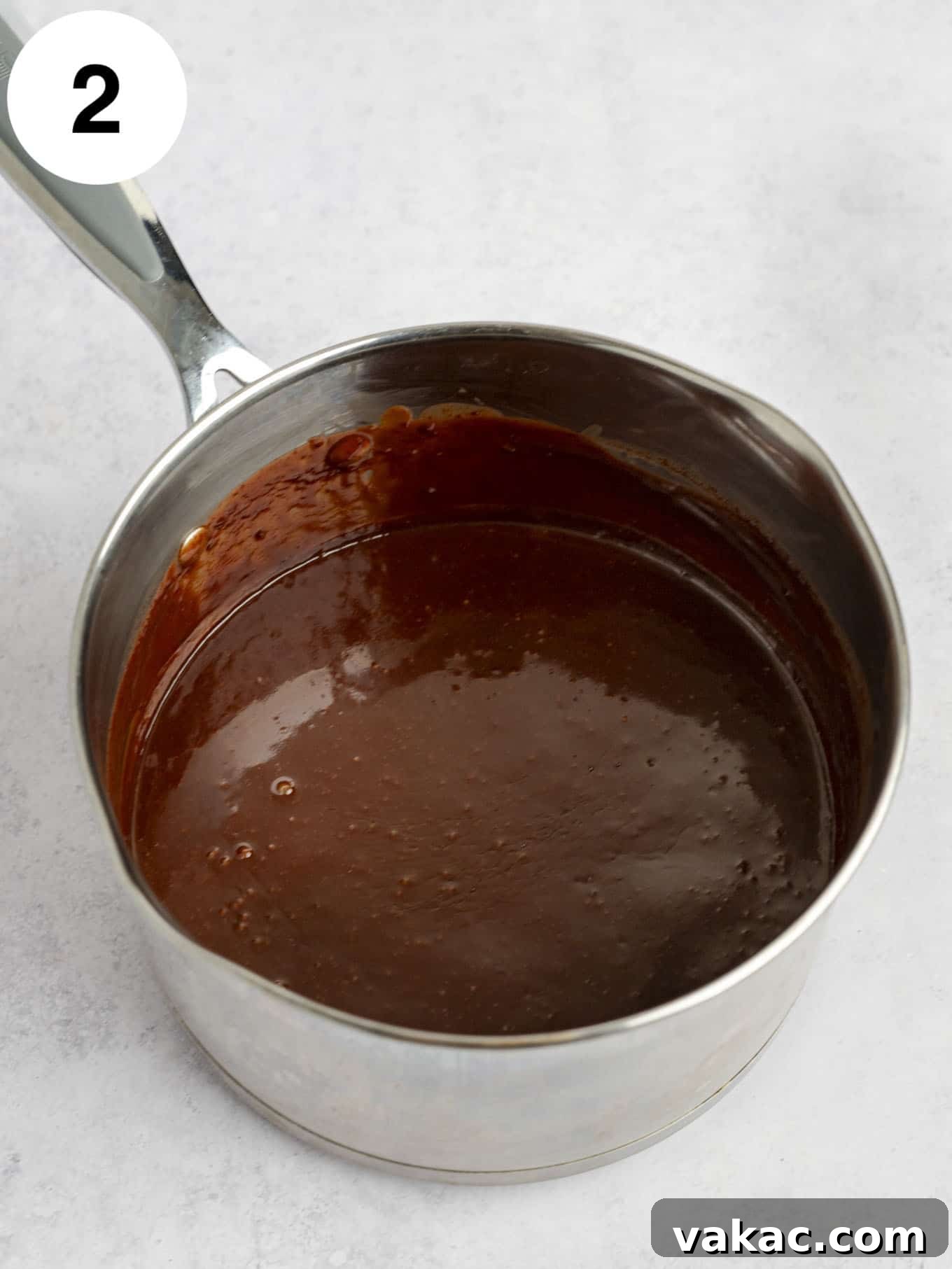 Decadent Homemade Hot Fudge Sauce 5 A metal saucepan full of classic fudge sauce.