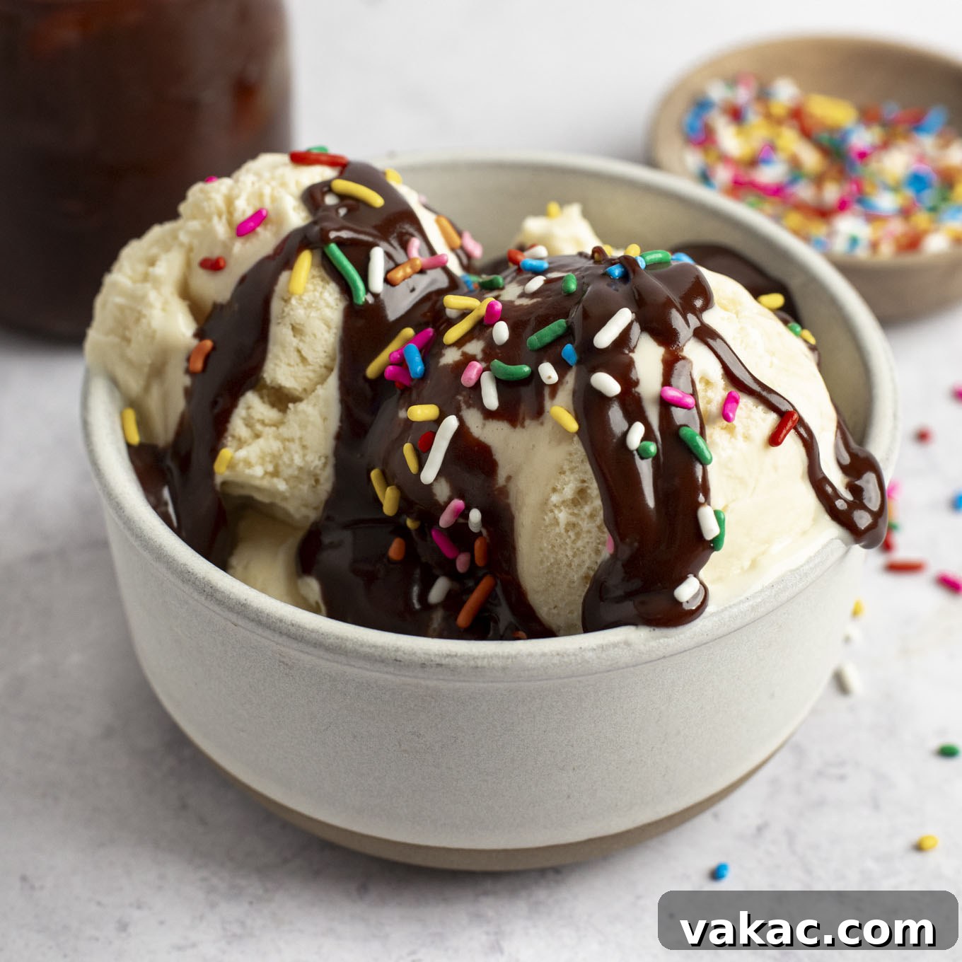 Decadent Homemade Hot Fudge Sauce 10 A bowl of ice cream topped with hot fudge sauce and sprinkles.