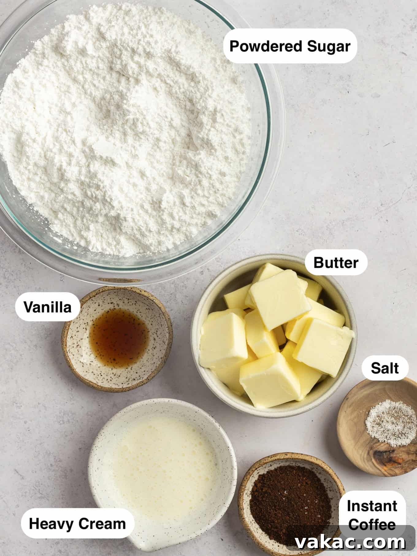 Java Dream Frost 3 An overhead view of the essential ingredients neatly laid out for making coffee frosting, including softened butter, powdered sugar, instant coffee, heavy cream, vanilla extract, and a pinch of salt.