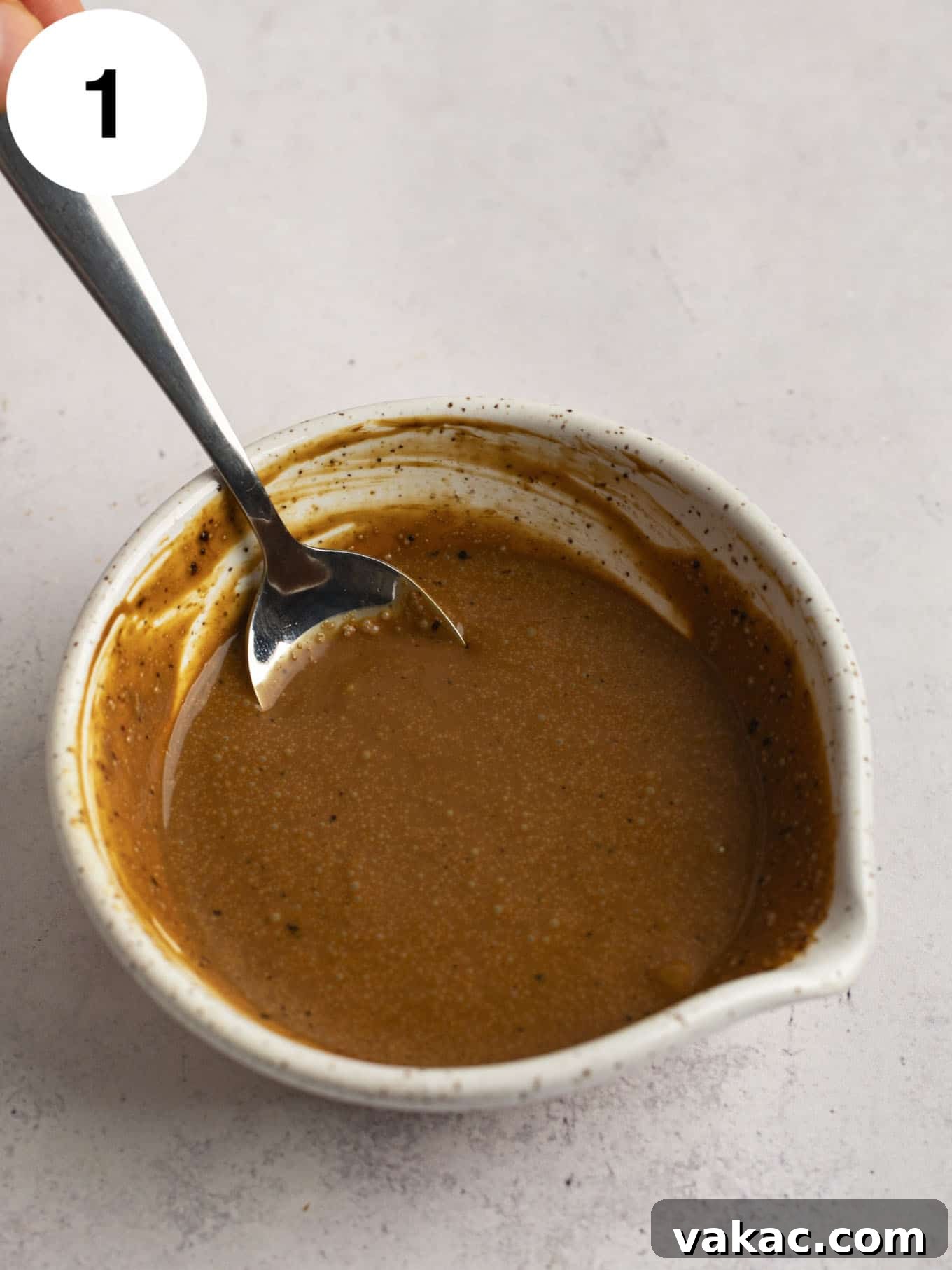 Java Dream Frost 4 Heavy cream and instant coffee granules being gently whisked together in a small bowl, showcasing the initial step of dissolving the coffee to create a concentrated coffee liquid.