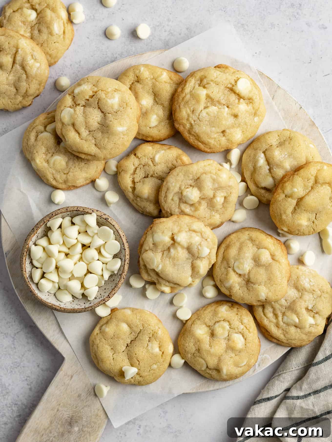 Irresistible White Chocolate Delights 2 An overhead view of freshly baked white chocolate chip cookies arranged beautifully on a rustic cutting board, highlighting their golden edges and creamy white chocolate chunks, ready to be served.