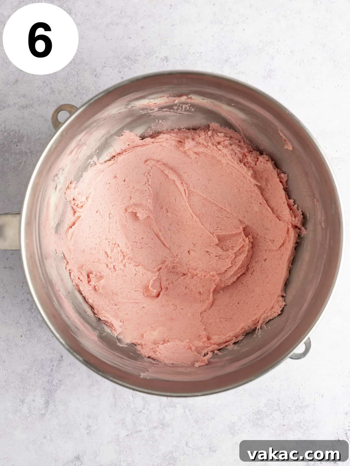 Velvet Raspberry Icing 13 An overhead view of freshly made raspberry frosting in a mixing bowl, showcasing its lighter pink hue compared to the freeze-dried version.