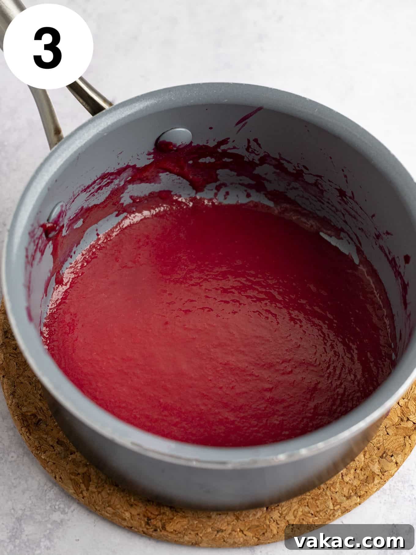 Velvet Raspberry Icing 10 Reduced, thickened raspberry puree simmering gently in a small saucepan over low heat, concentrating its flavor.