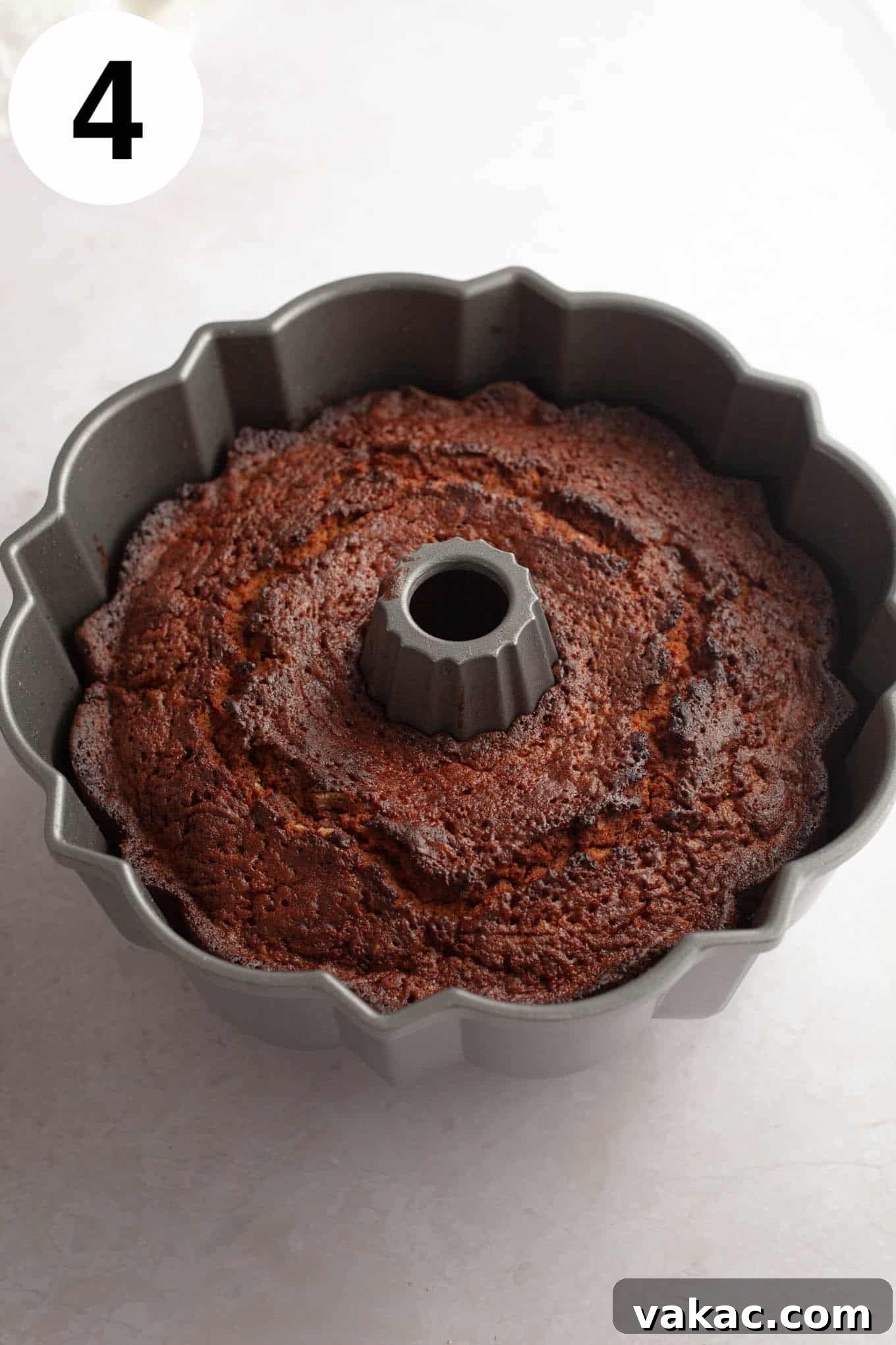 Cinnamon Sugar Cider Cake 7 An overhead view of a baked apple cider donut cake in a bundt pan.